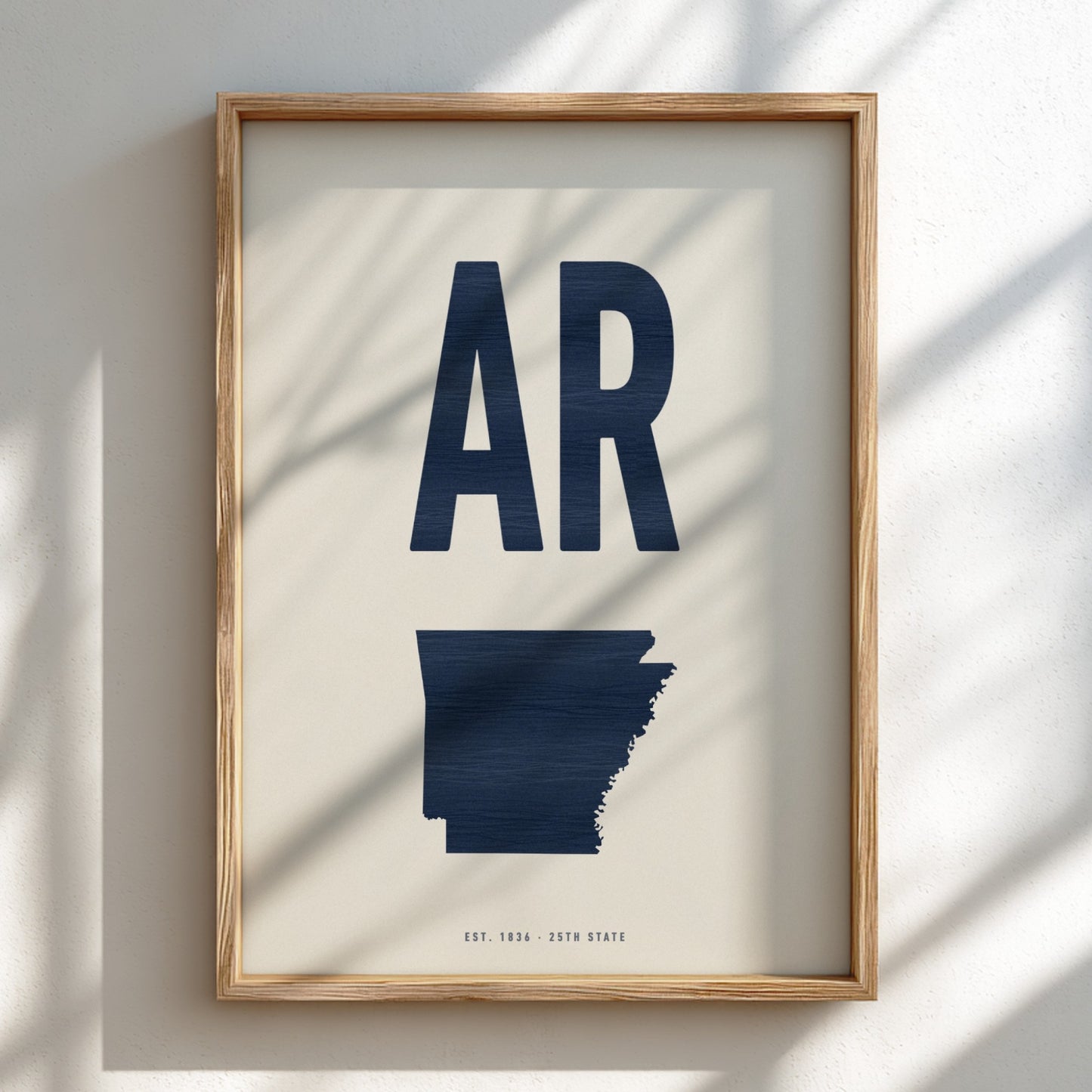 Framed artwork with 'AR' and a map of Arkansas on a light background