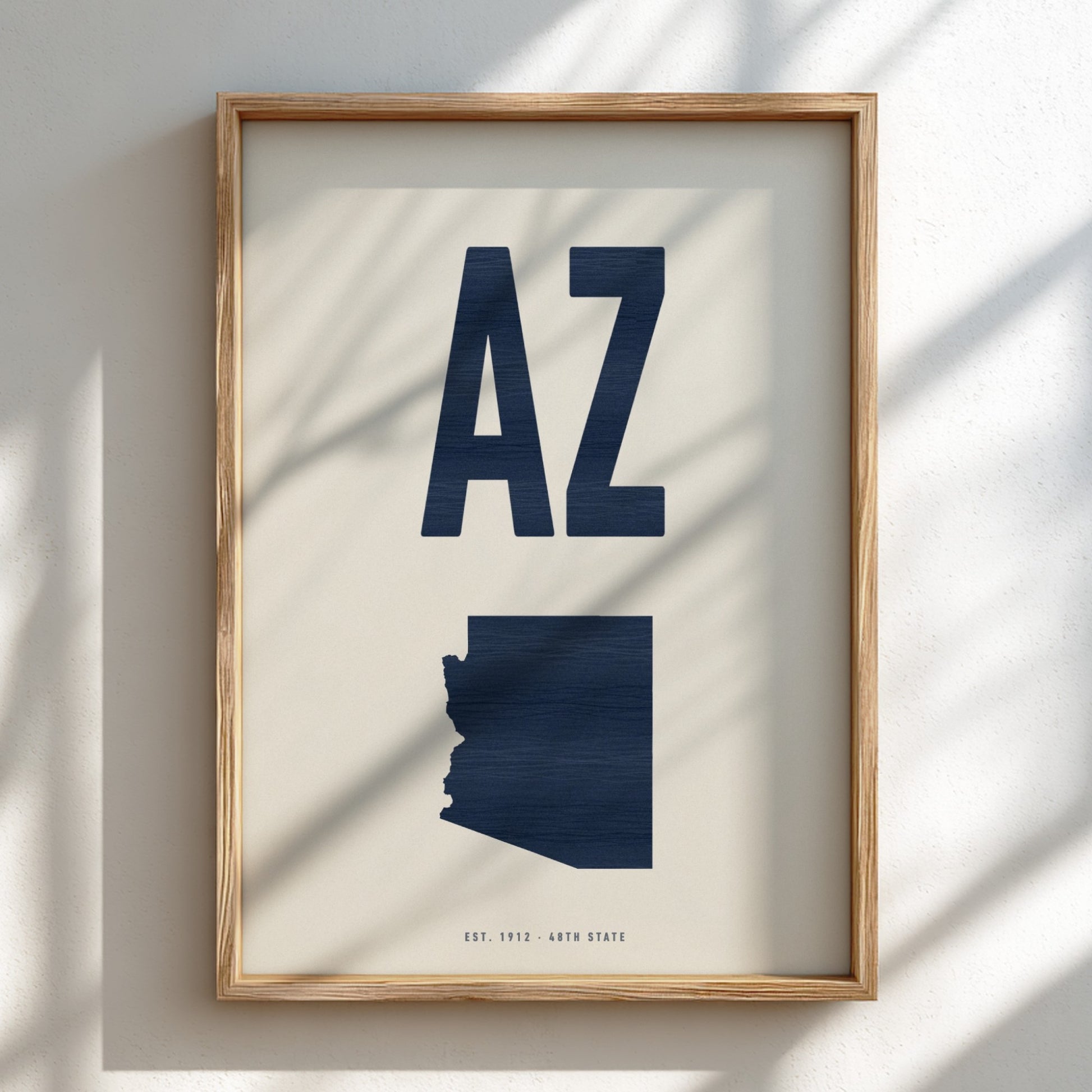 Framed artwork with 'AZ' and a map of Arizona on a light background