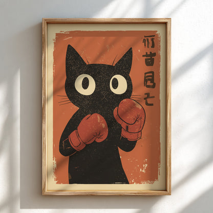 Framed art print featuring a black cat with large white eyes and red boxing gloves on an orange background, hung on a white wall with soft diagonal shadows.