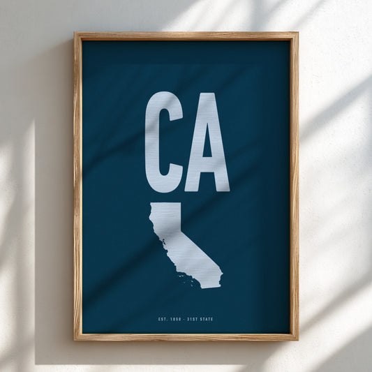 Framed artwork of a white 'CA' on a blue background, likely representing California.