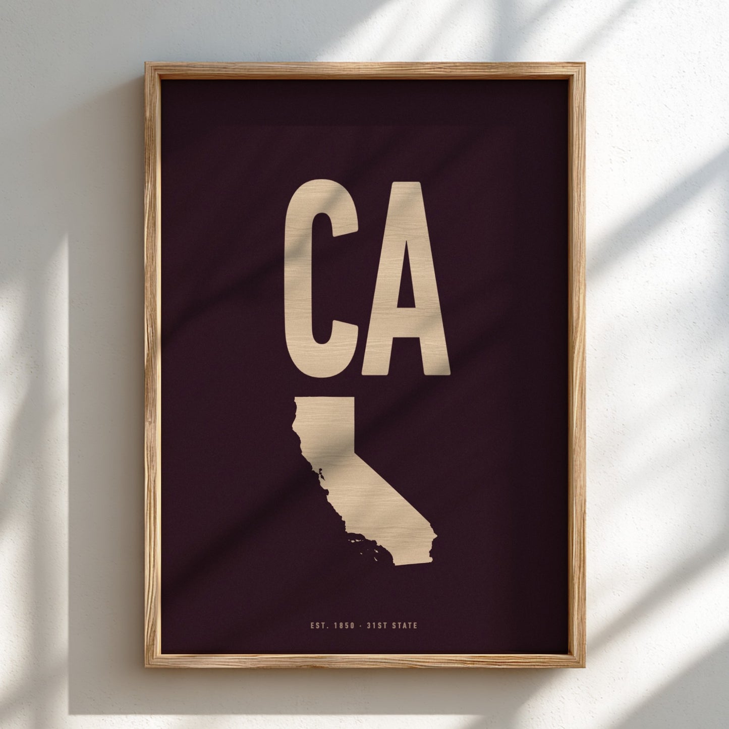 Framed artwork with 'CA' and outline of California on a dark background