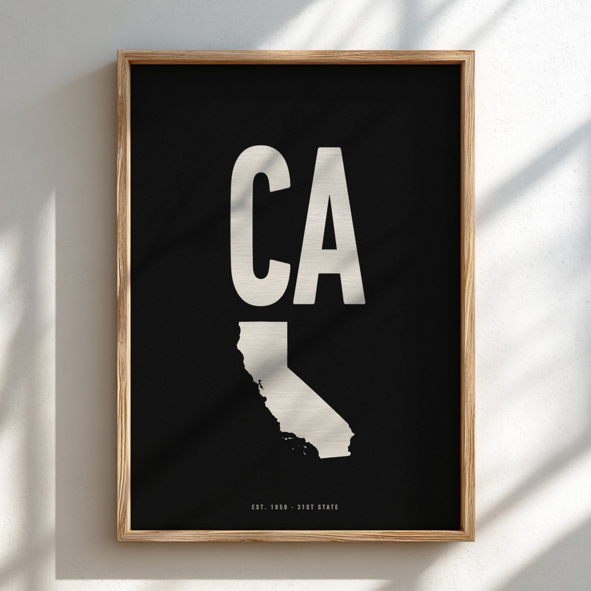 Framed artwork with 'CA' and outline of California on a black background