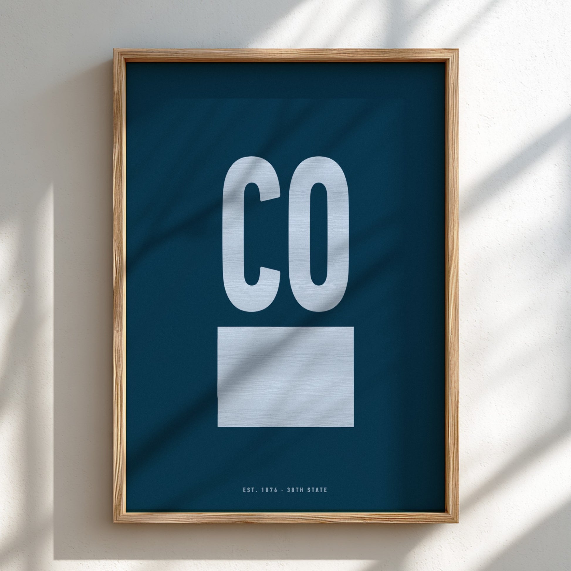 Framed poster with 'CO' on a blue background