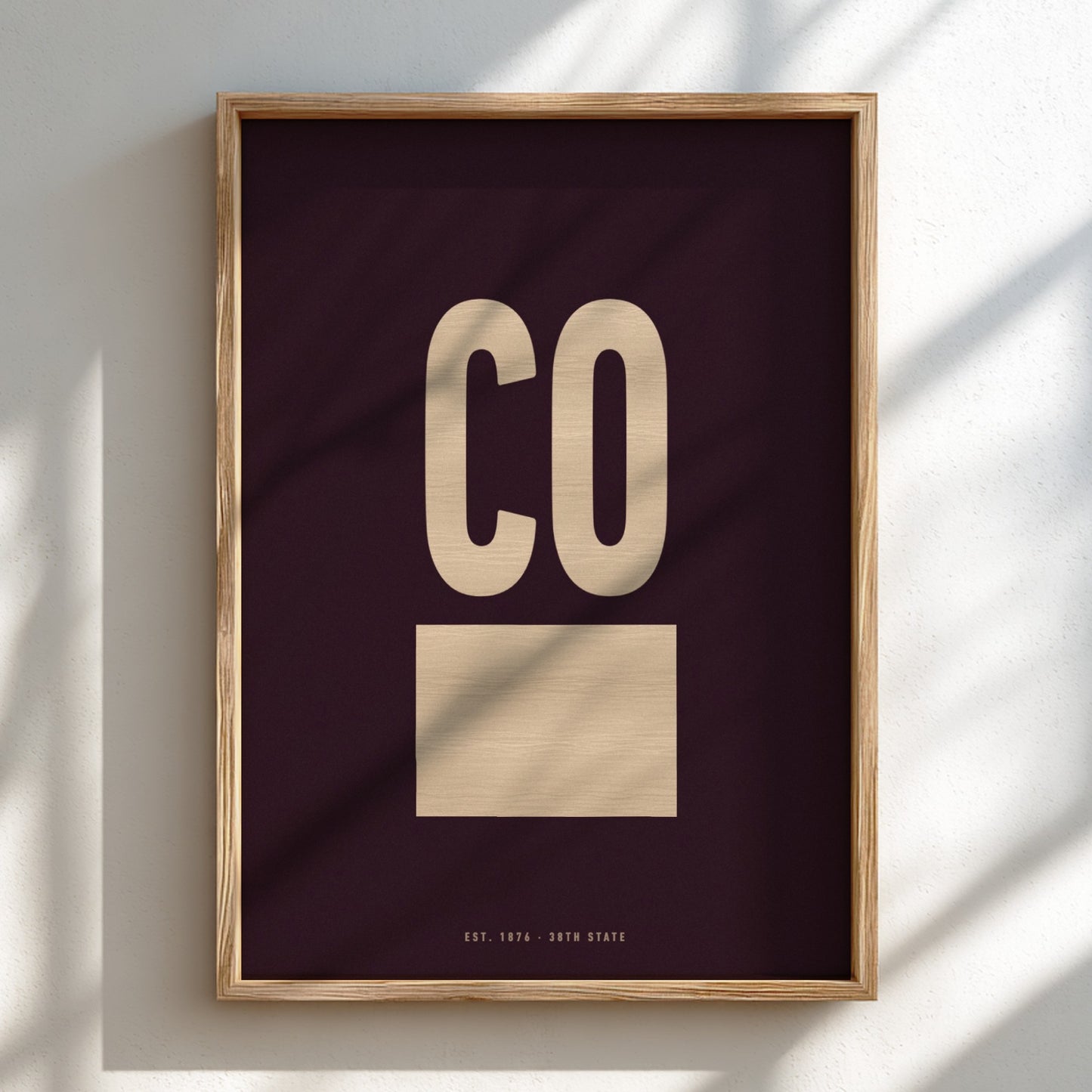 Framed artwork with 'CO' on a dark background