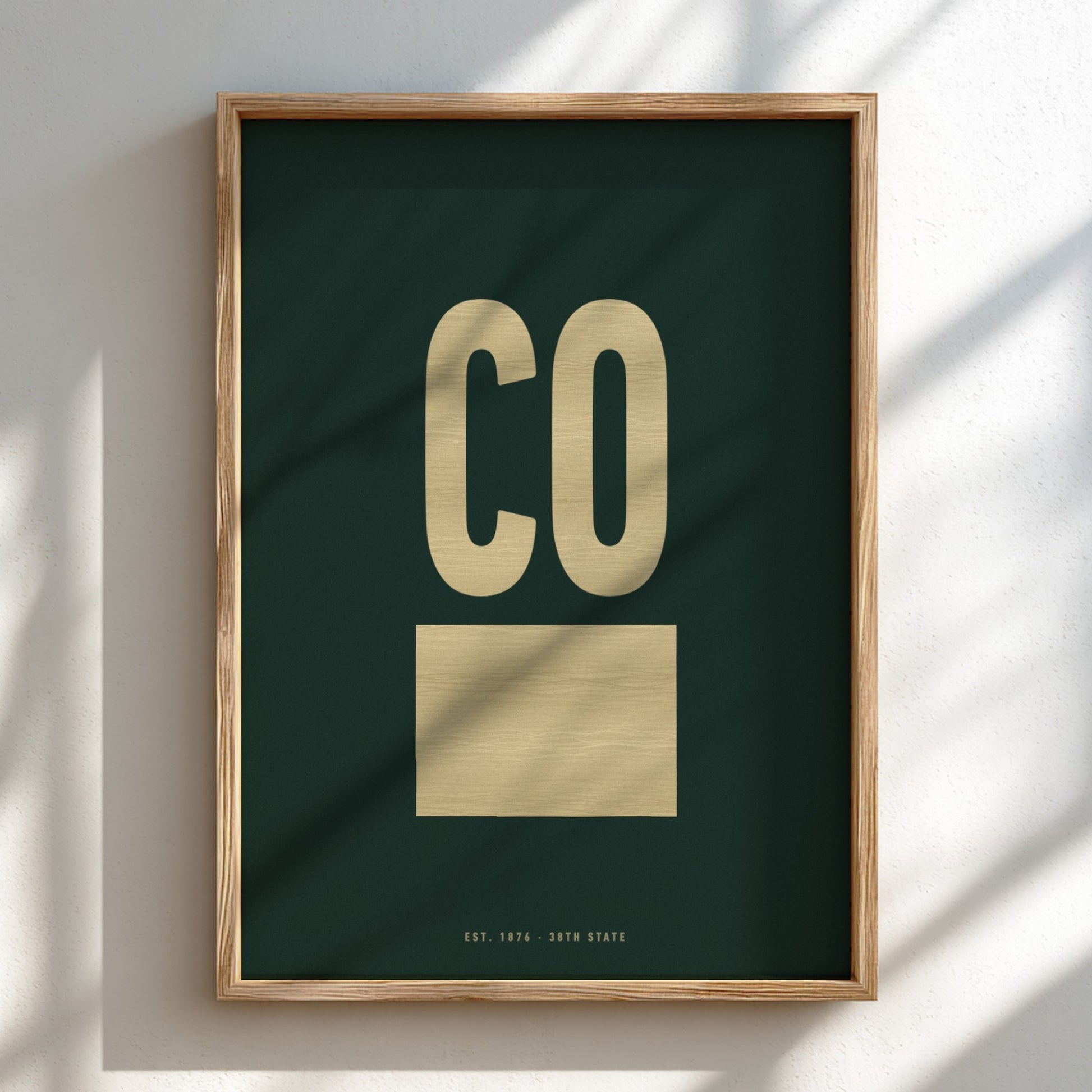 Framed artwork with 'CO' on a dark green background