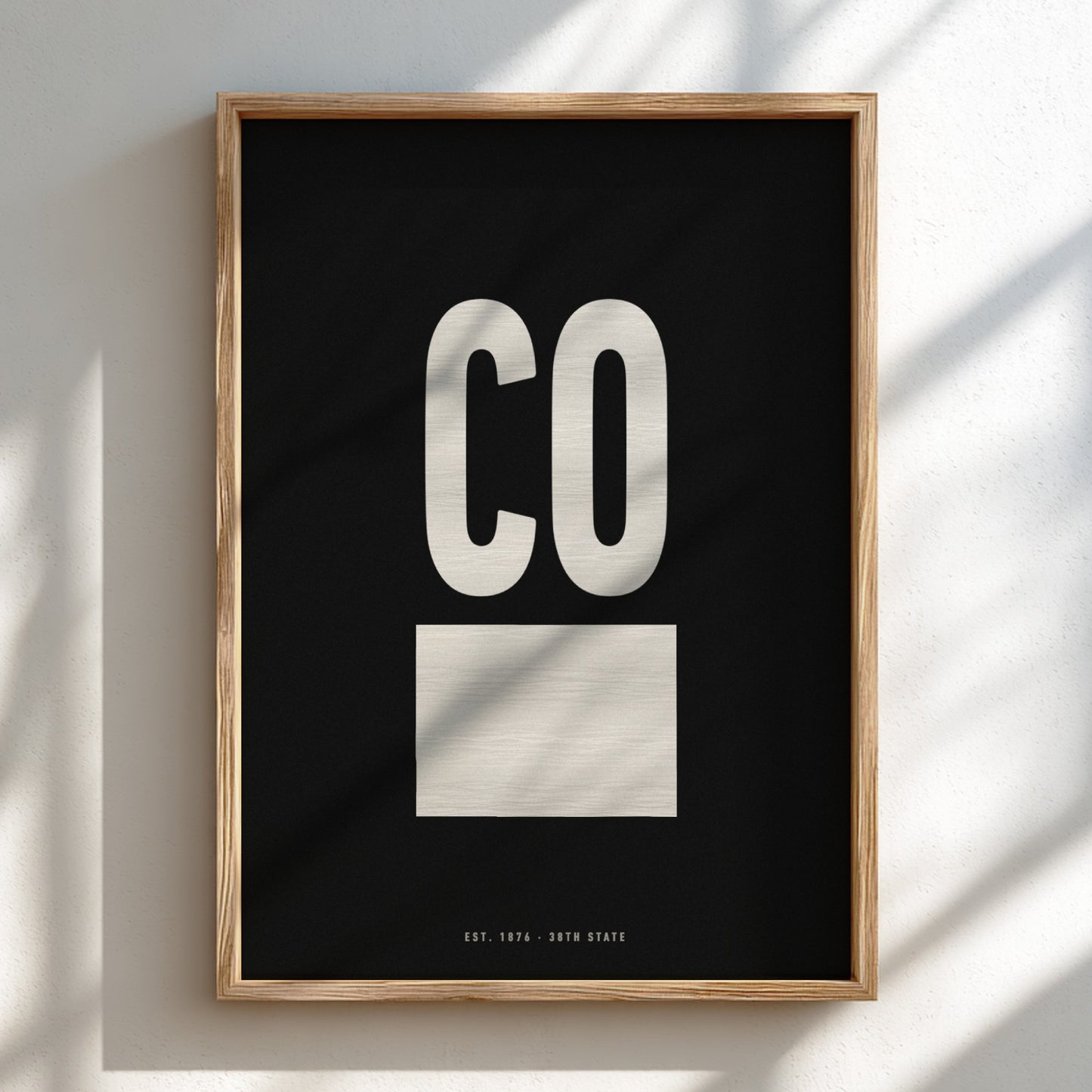 Framed artwork with 'CO' on a black background