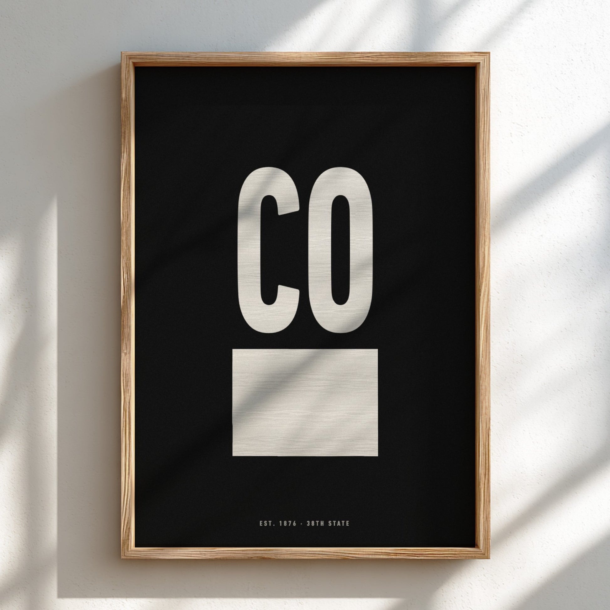 Framed artwork with 'CO' on a black background
