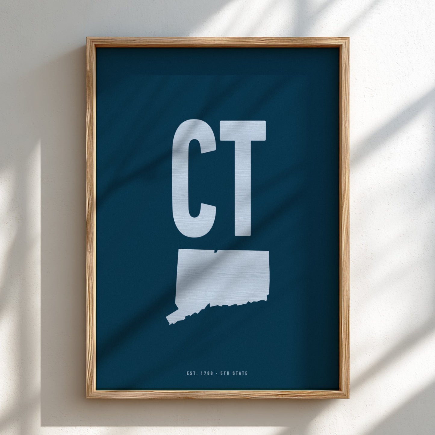 Framed artwork with 'CT' on a blue background