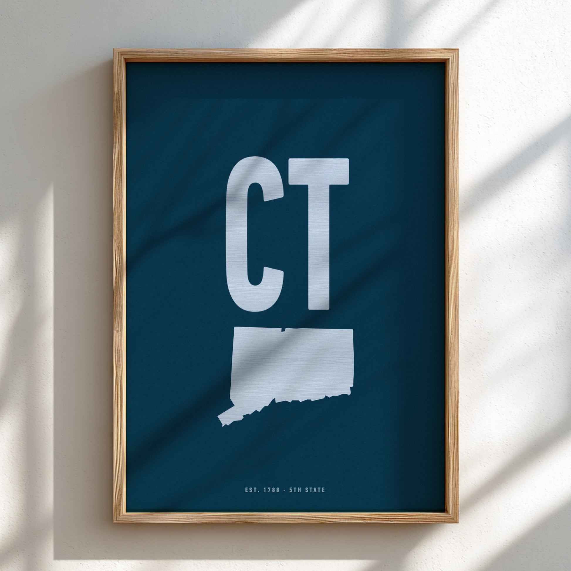 Framed artwork with 'CT' on a blue background