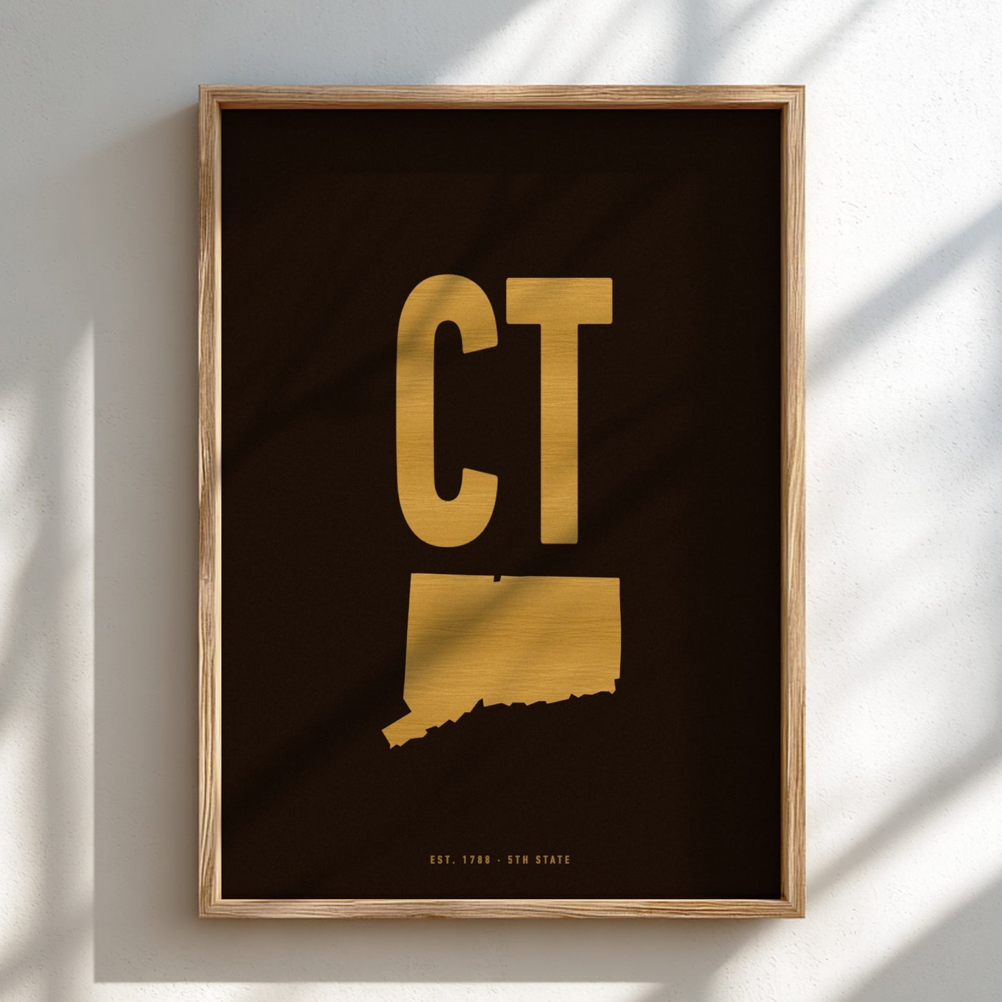 Framed artwork with gold 'CT' on a black background