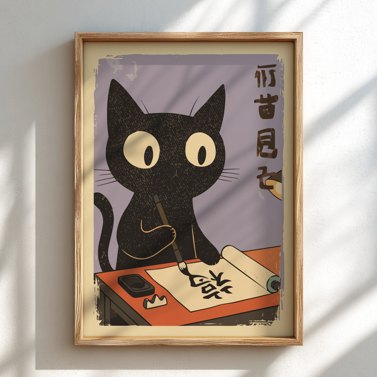 A framed art print featuring a black cat with large white eyes writing on a scroll, displayed on a light wall with soft window shadows.