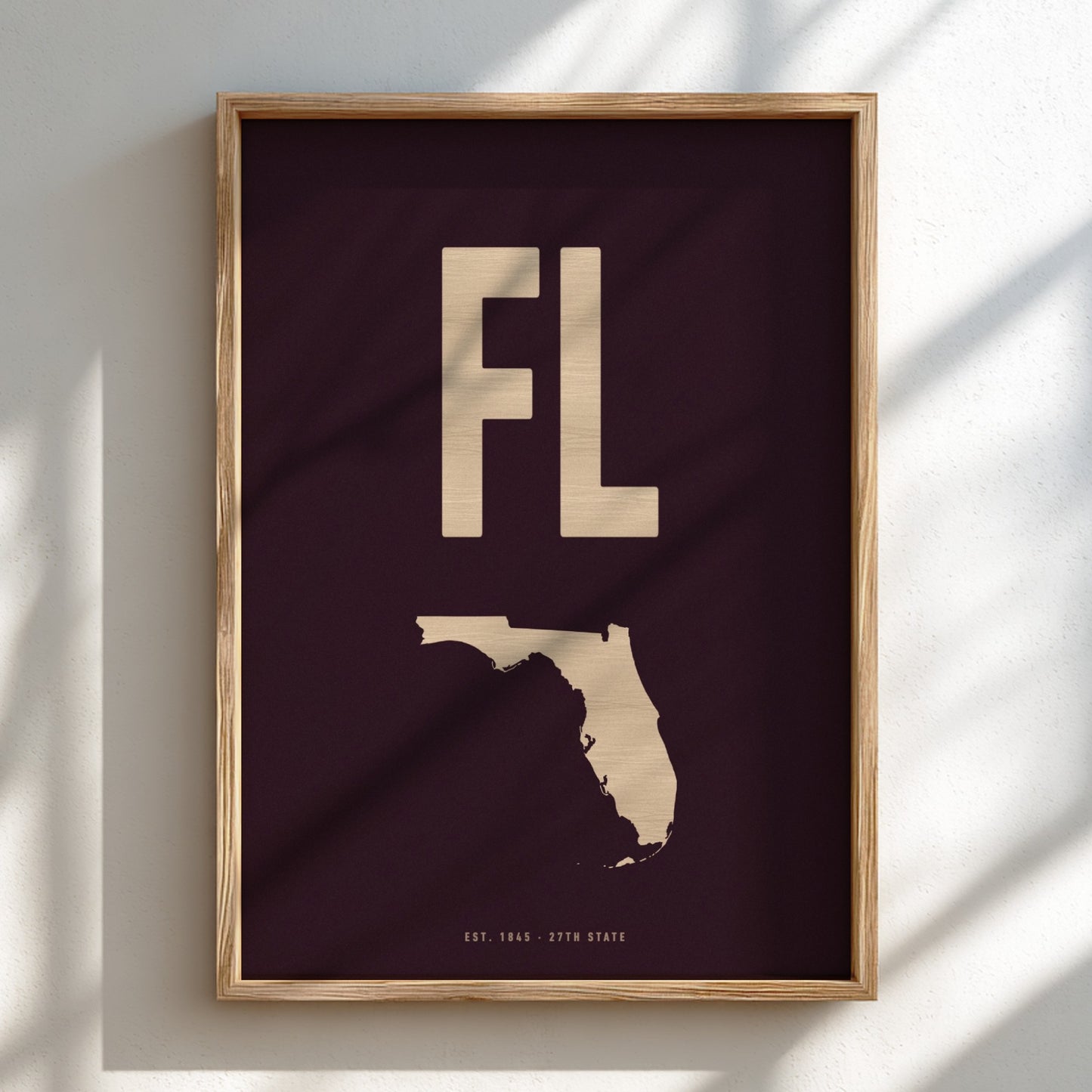 Framed artwork with 'FL' and outline of Florida on a dark background