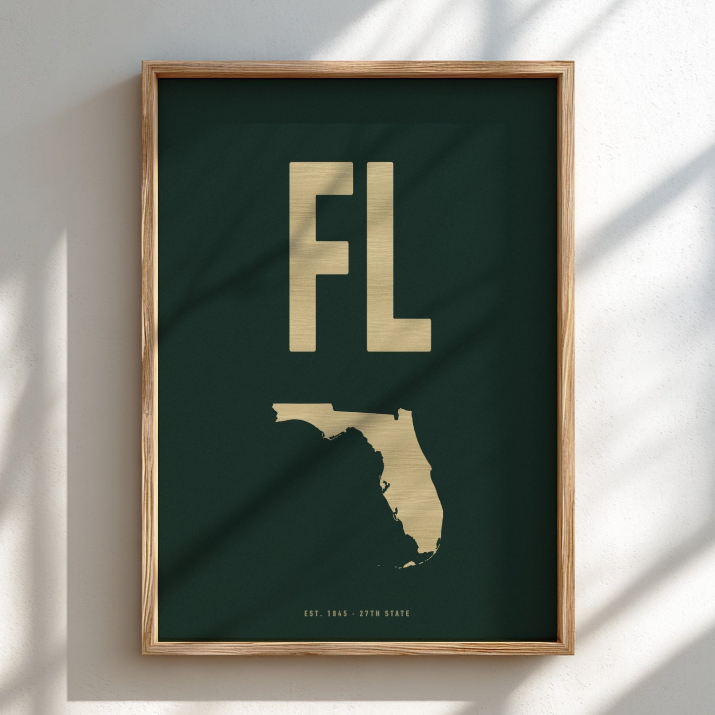 Framed artwork with 'FL' and outline of Florida on a dark green background