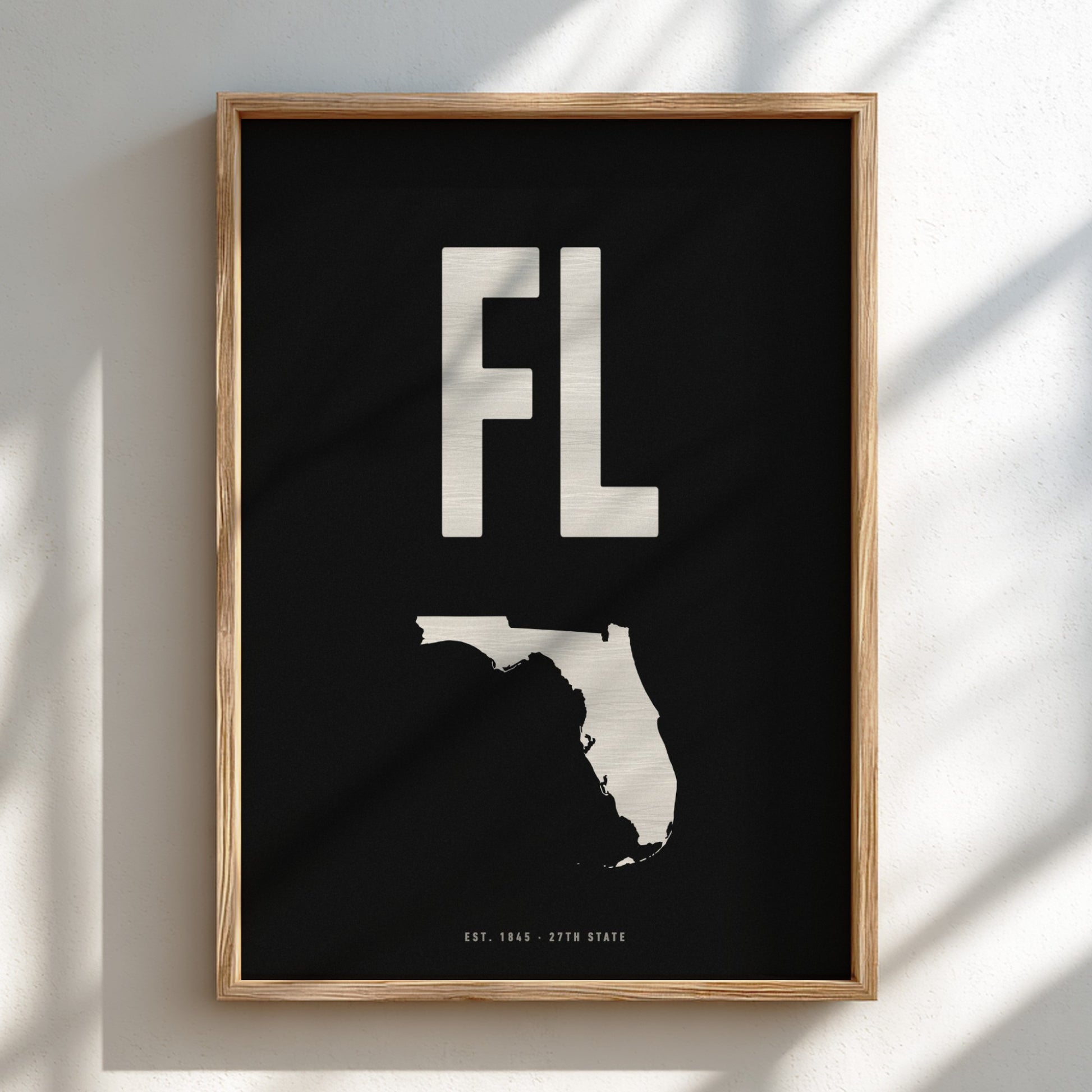 Framed artwork with 'FL' and outline of Florida on a black background