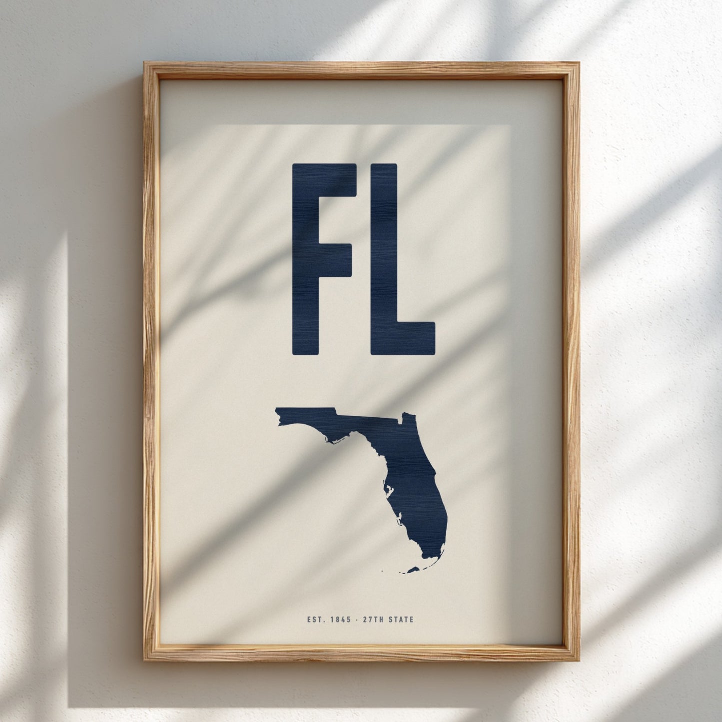 Framed artwork with 'FL' and a map of Florida on a light background