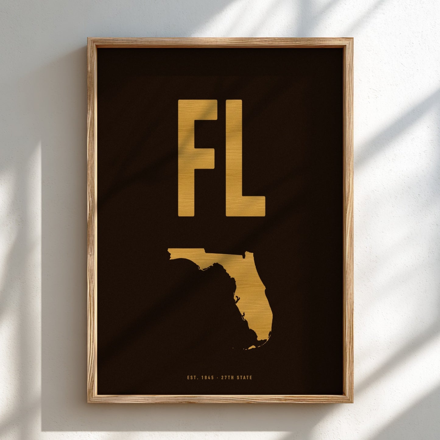 Framed artwork with gold 'FL' and outline of Florida on a dark background