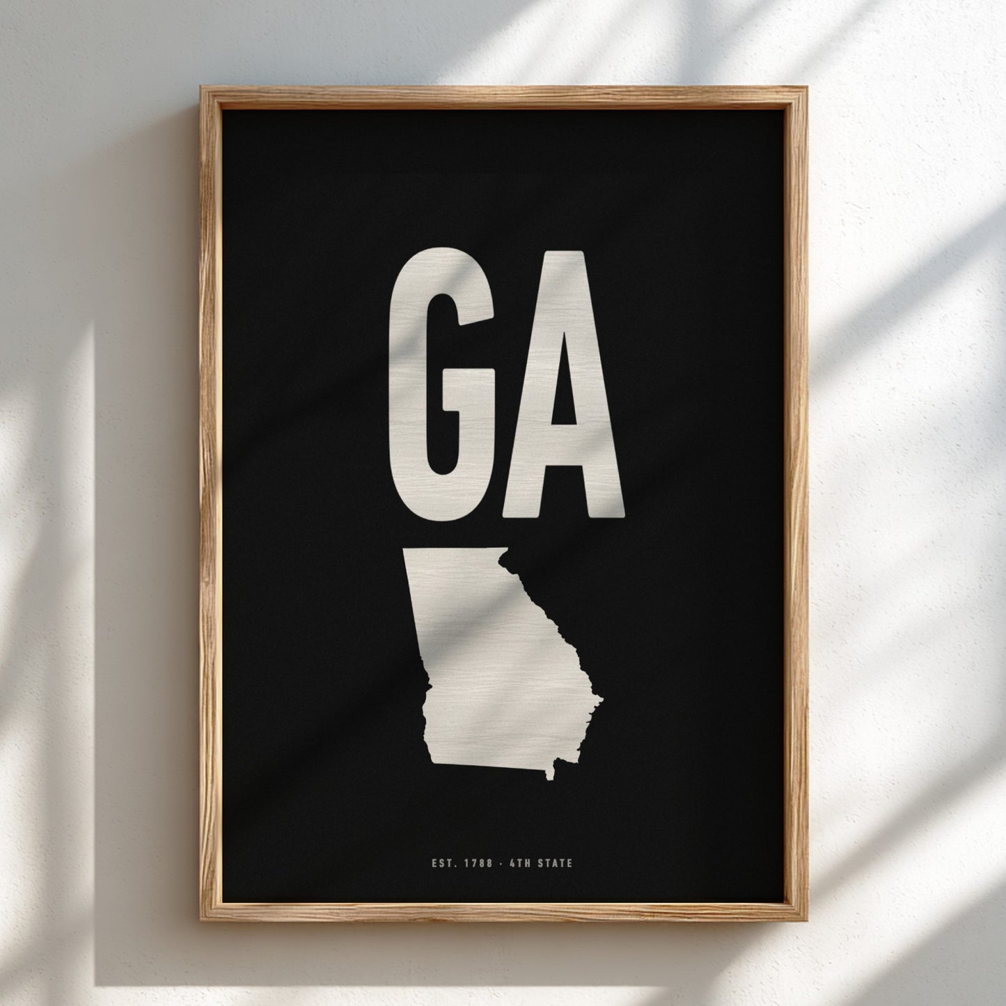 Framed artwork with 'GA' and a map of Georgia on a black background