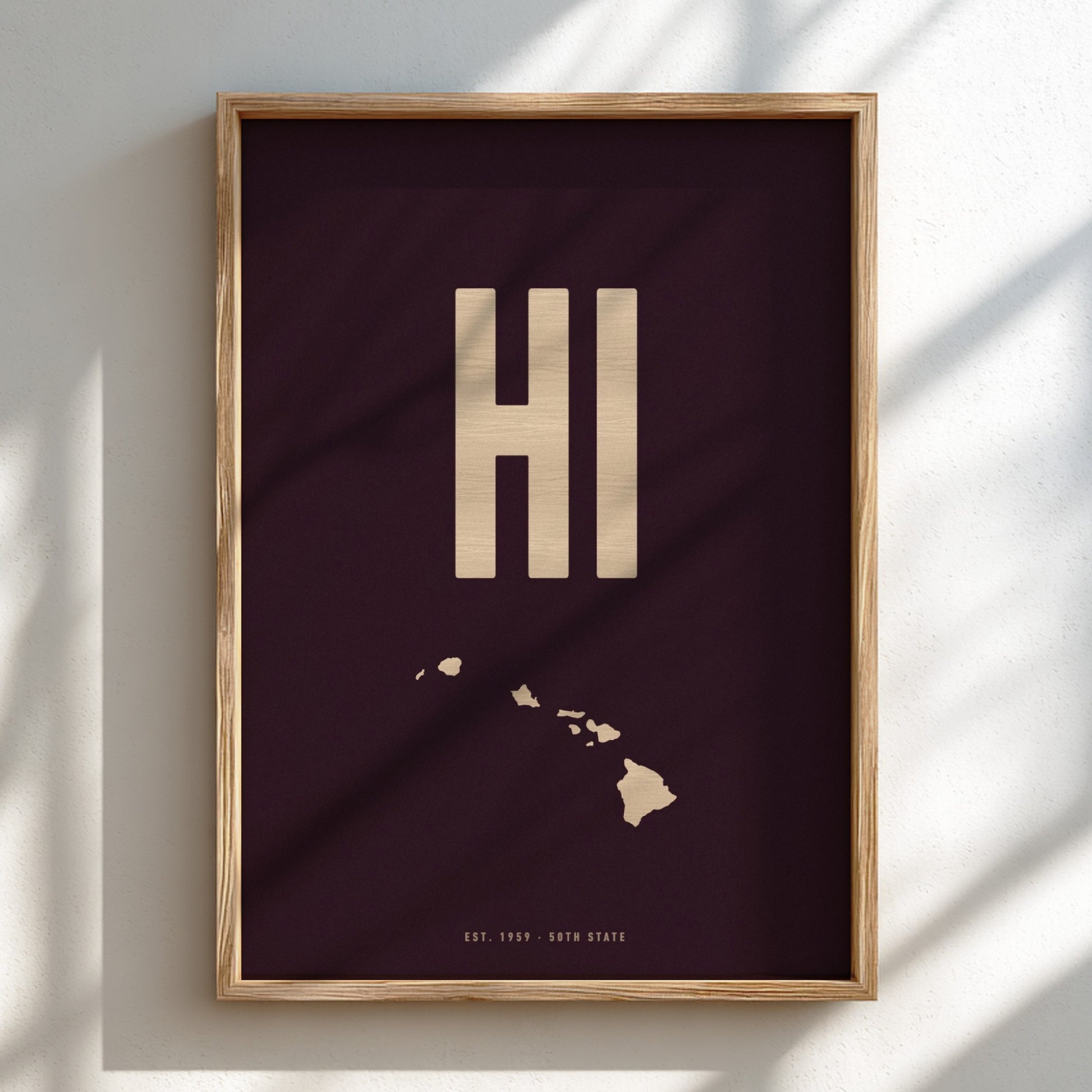 Framed artwork with 'HI' initials and a map of Hawaii on a dark background
