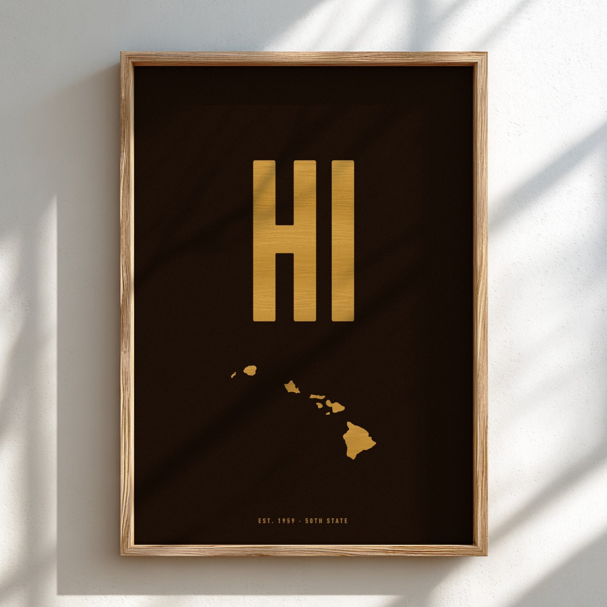 Framed artwork with 'HI' in gold on a dark background