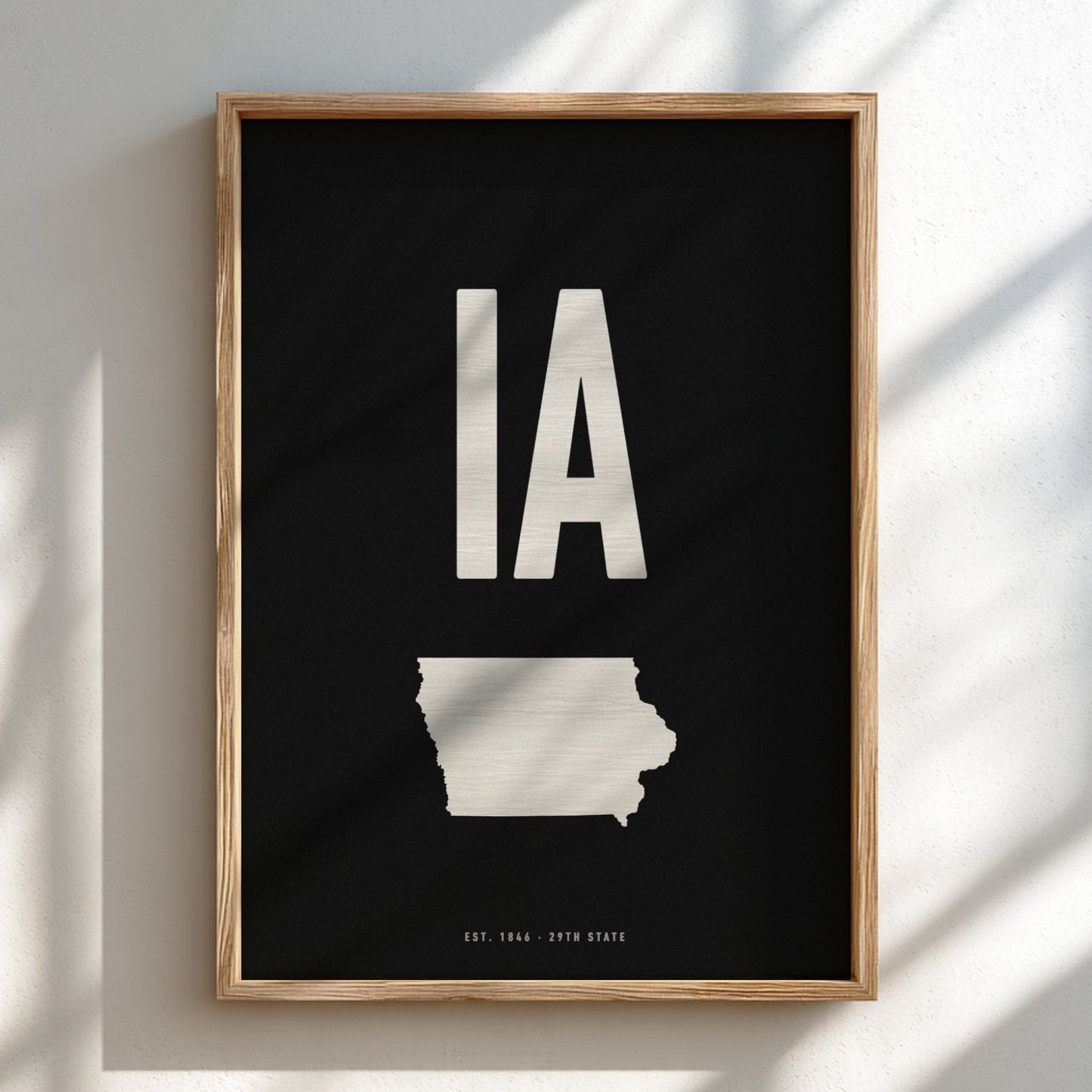 Framed poster of Iowa with 'IA' on a black background