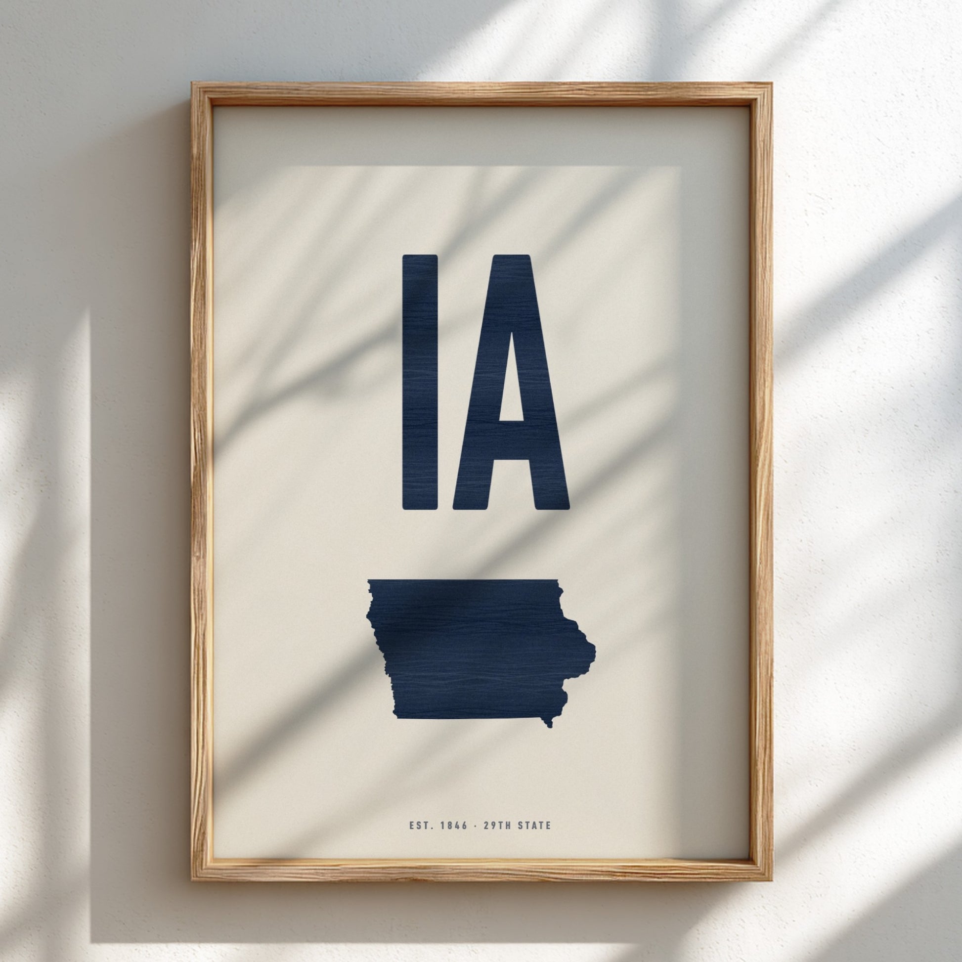 Framed artwork of the state of Iowa with 'IA' on a light background
