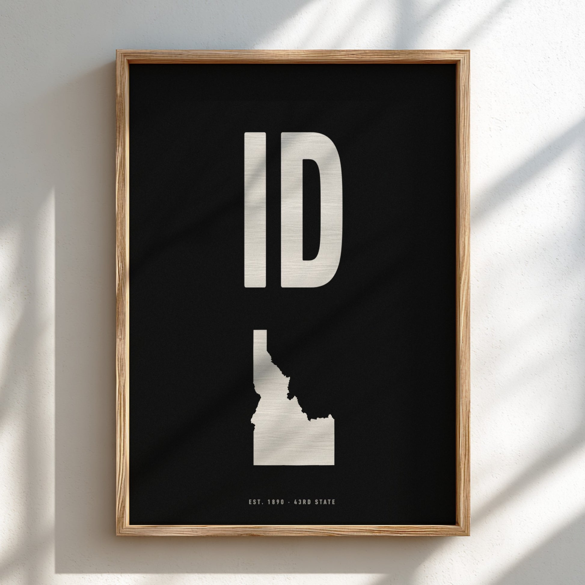 Framed artwork with 'ID' and a map of Idaho on a black background