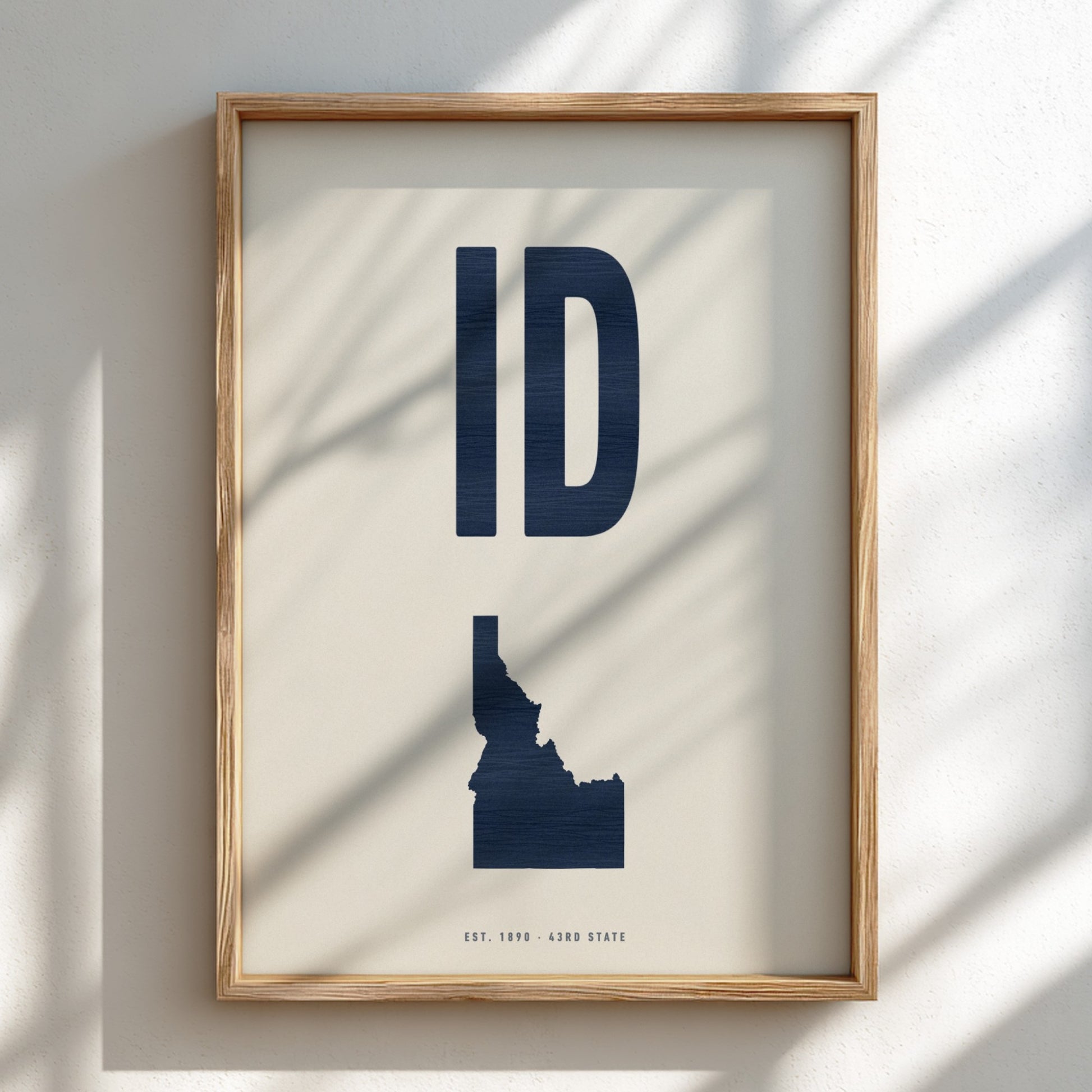 Framed artwork of Idaho's state abbreviation 'ID' on a light background