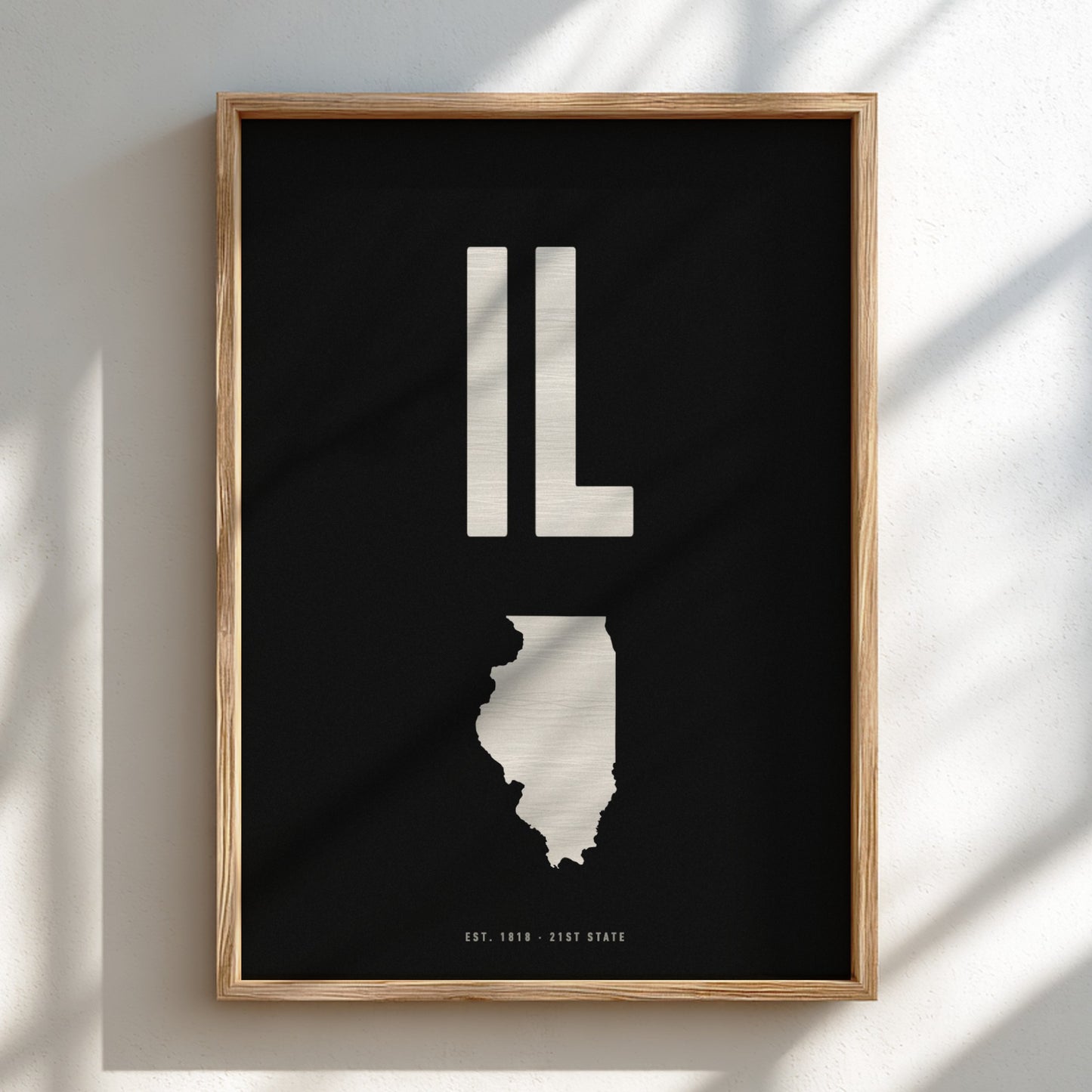 Framed artwork of the state of Illinois with 'IL' on a black background