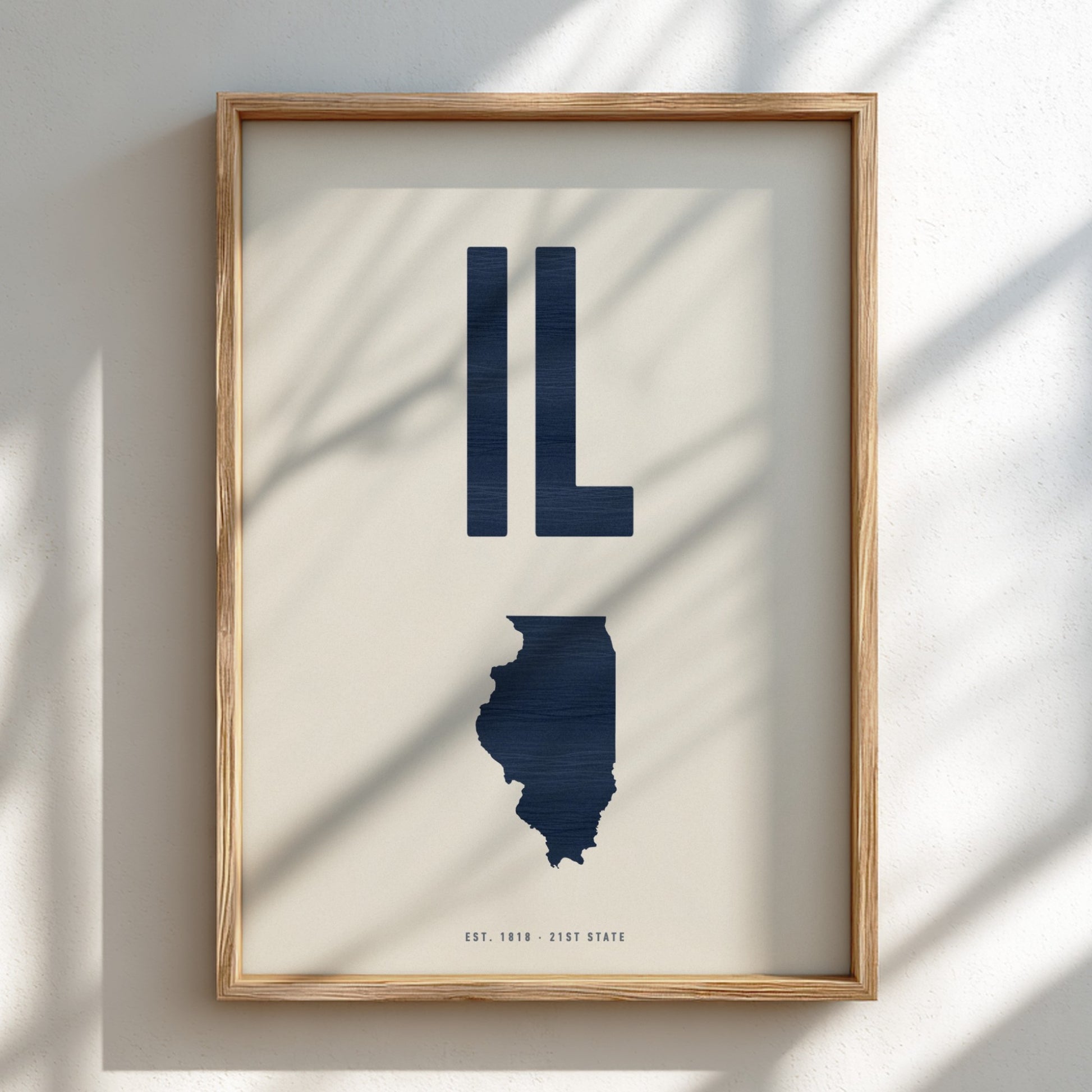 Framed artwork of the state of Illinois with 'IL' in navy on a light background
