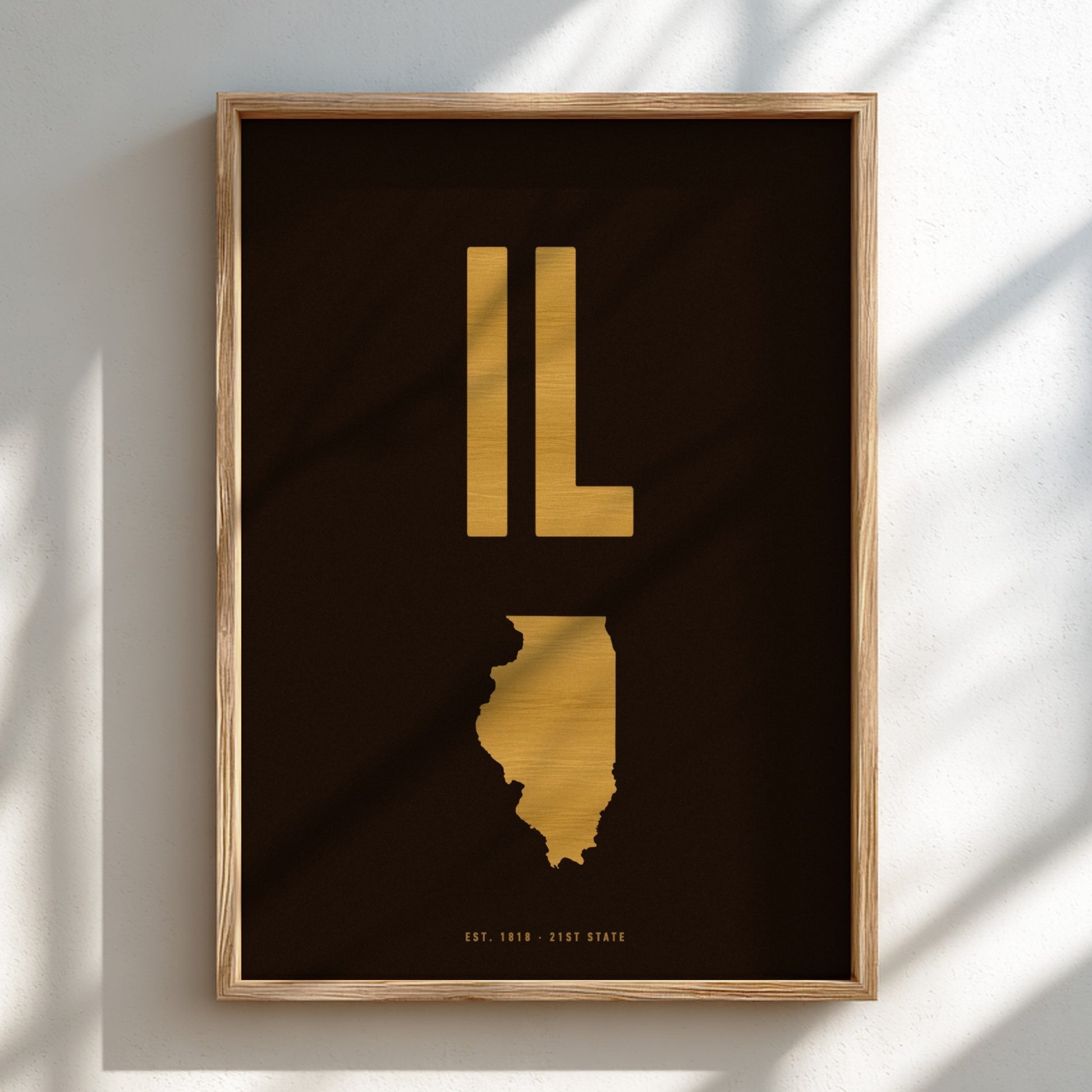 Framed artwork of the state of Illinois in gold on a dark background