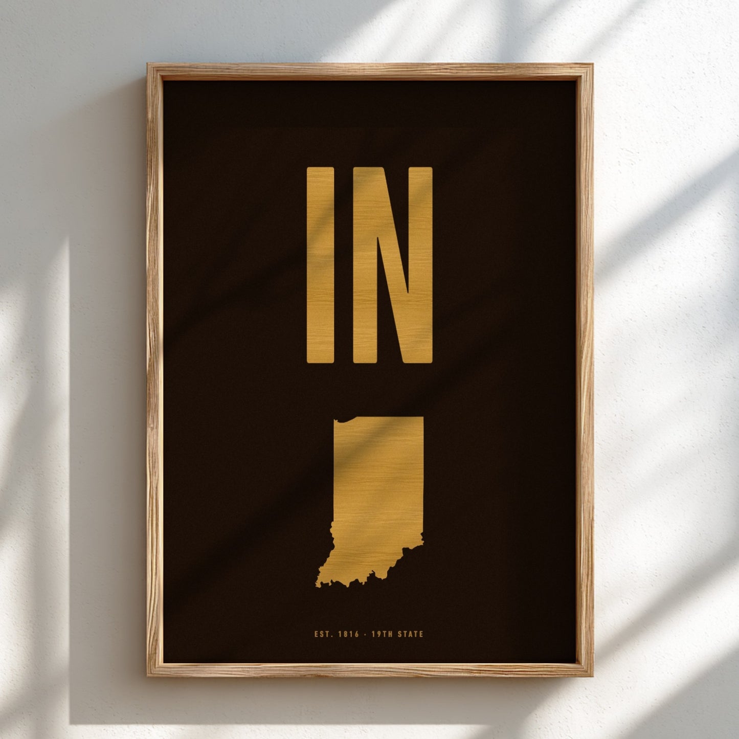 Framed artwork with gold state outline and 'IN' on a black background