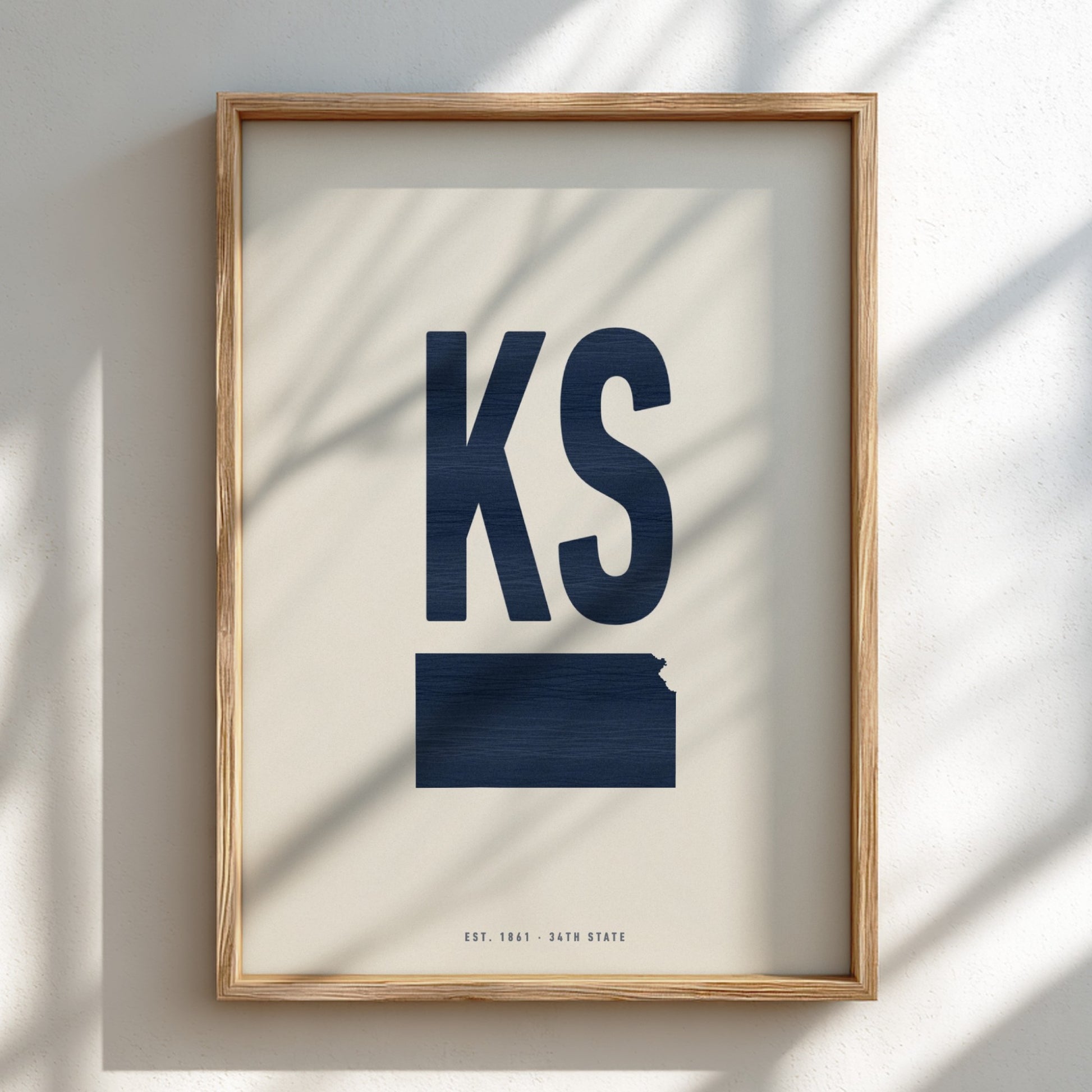 Framed artwork with 'KS' in blue on a beige background