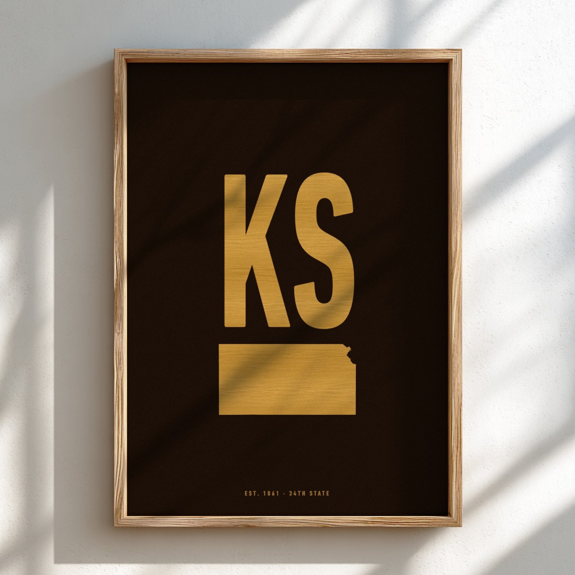 Framed artwork with 'KS' in gold on a black background