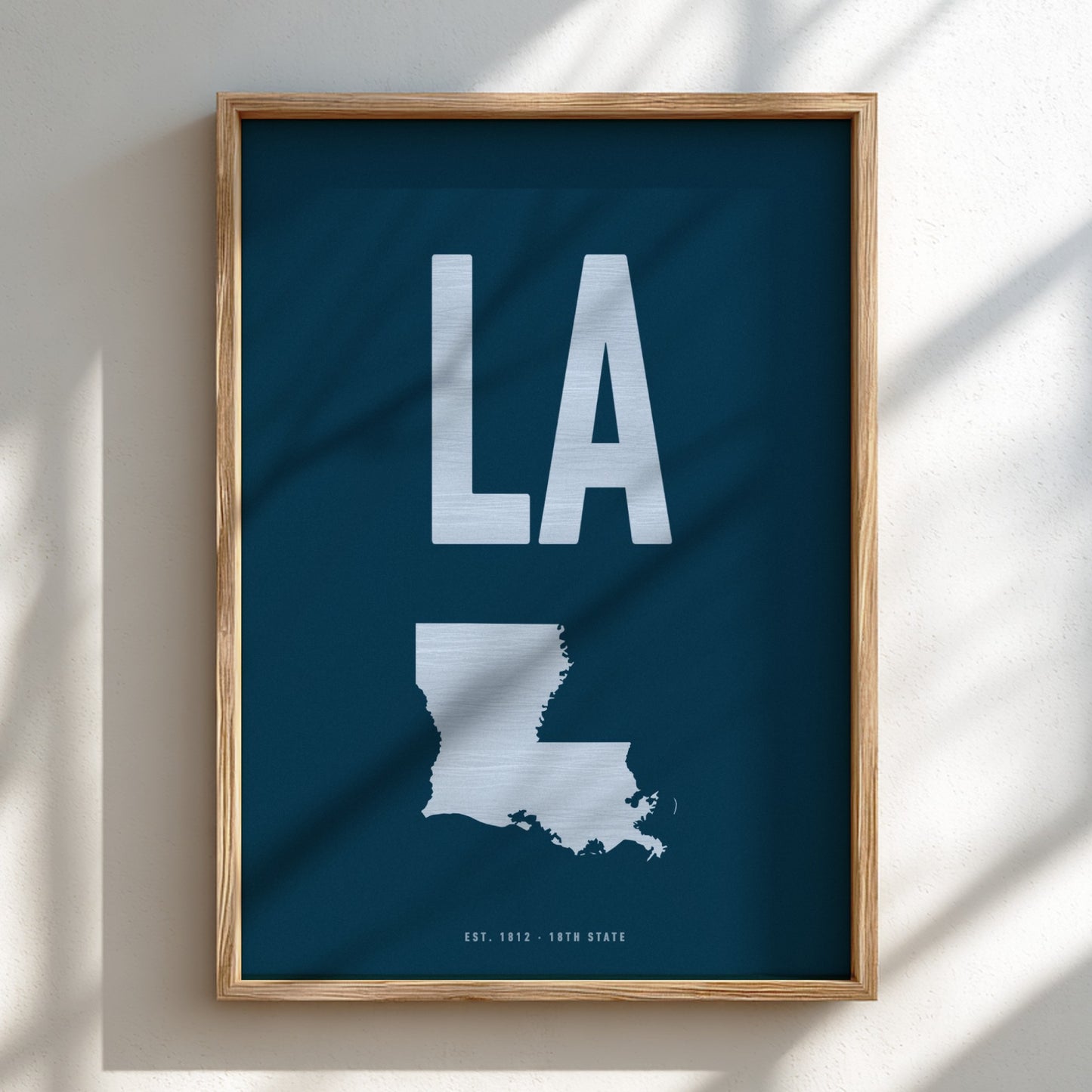 Framed poster with 'LA' and a map of Louisiana on a blue background