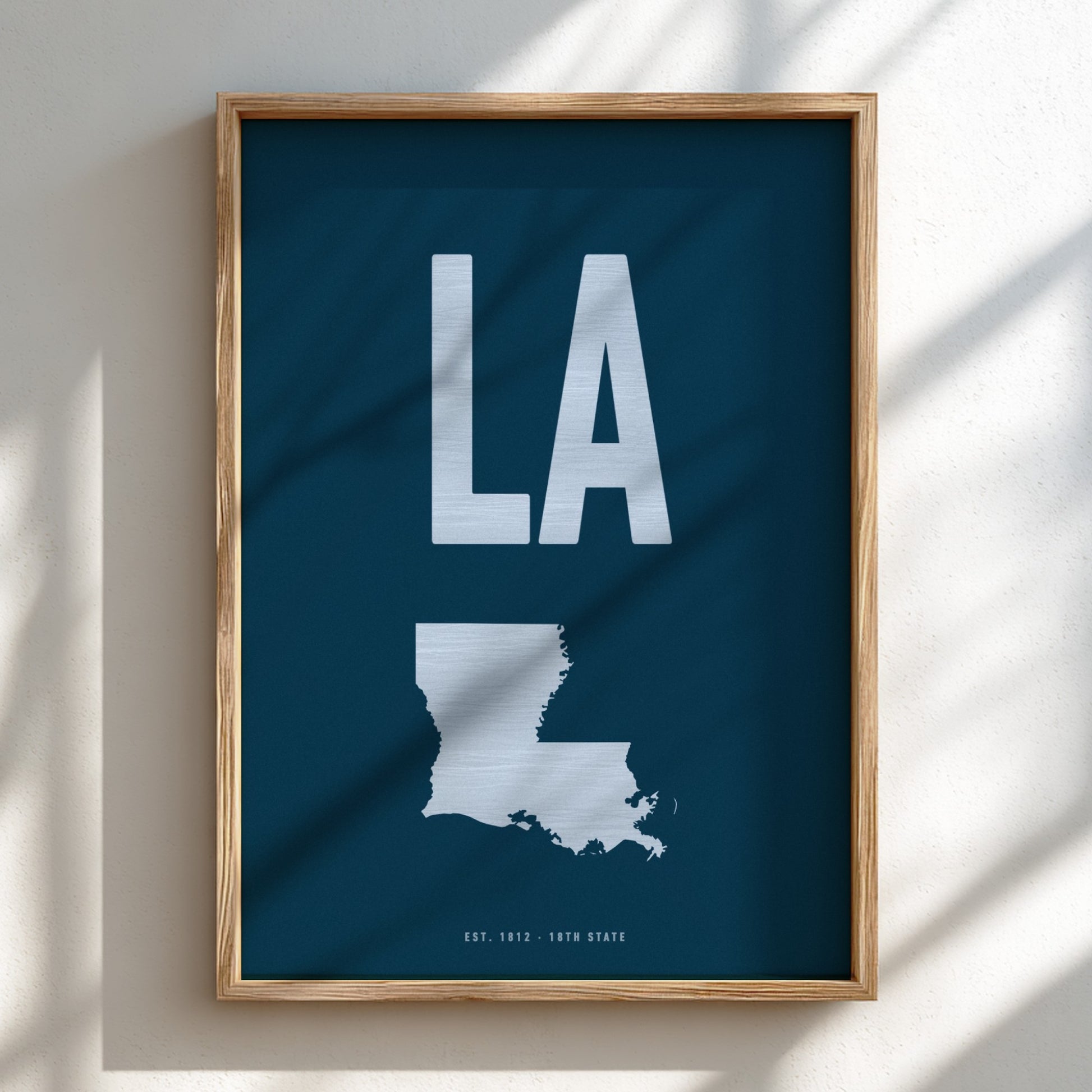 Framed poster with 'LA' and a map of Louisiana on a blue background