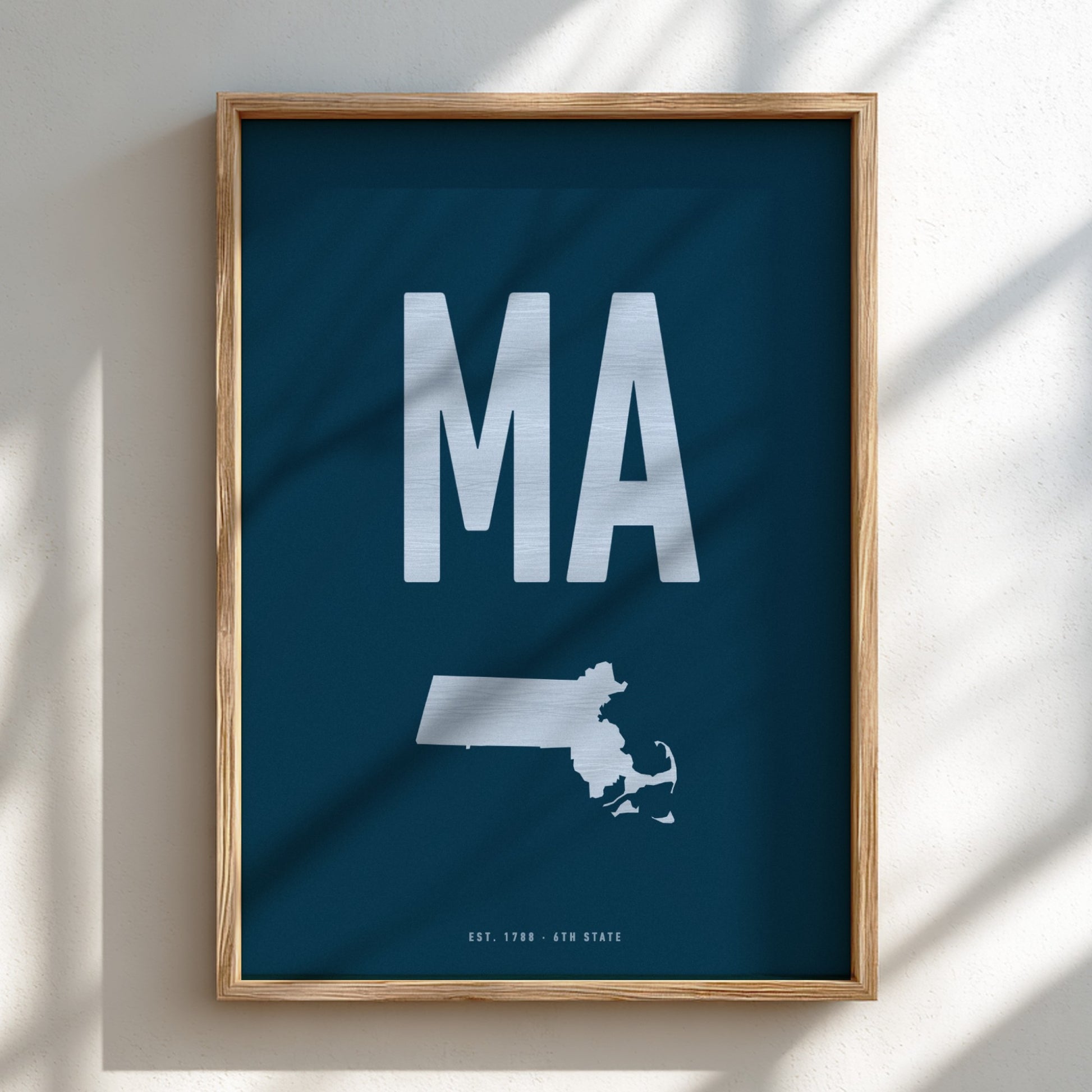 Framed poster with 'MA' and a map of Massachusetts on a blue background