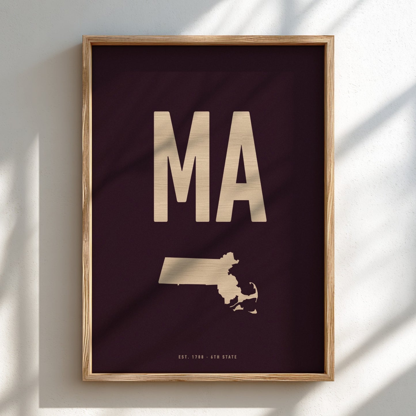 Framed poster with 'MA' and a map of Massachusetts on a dark background