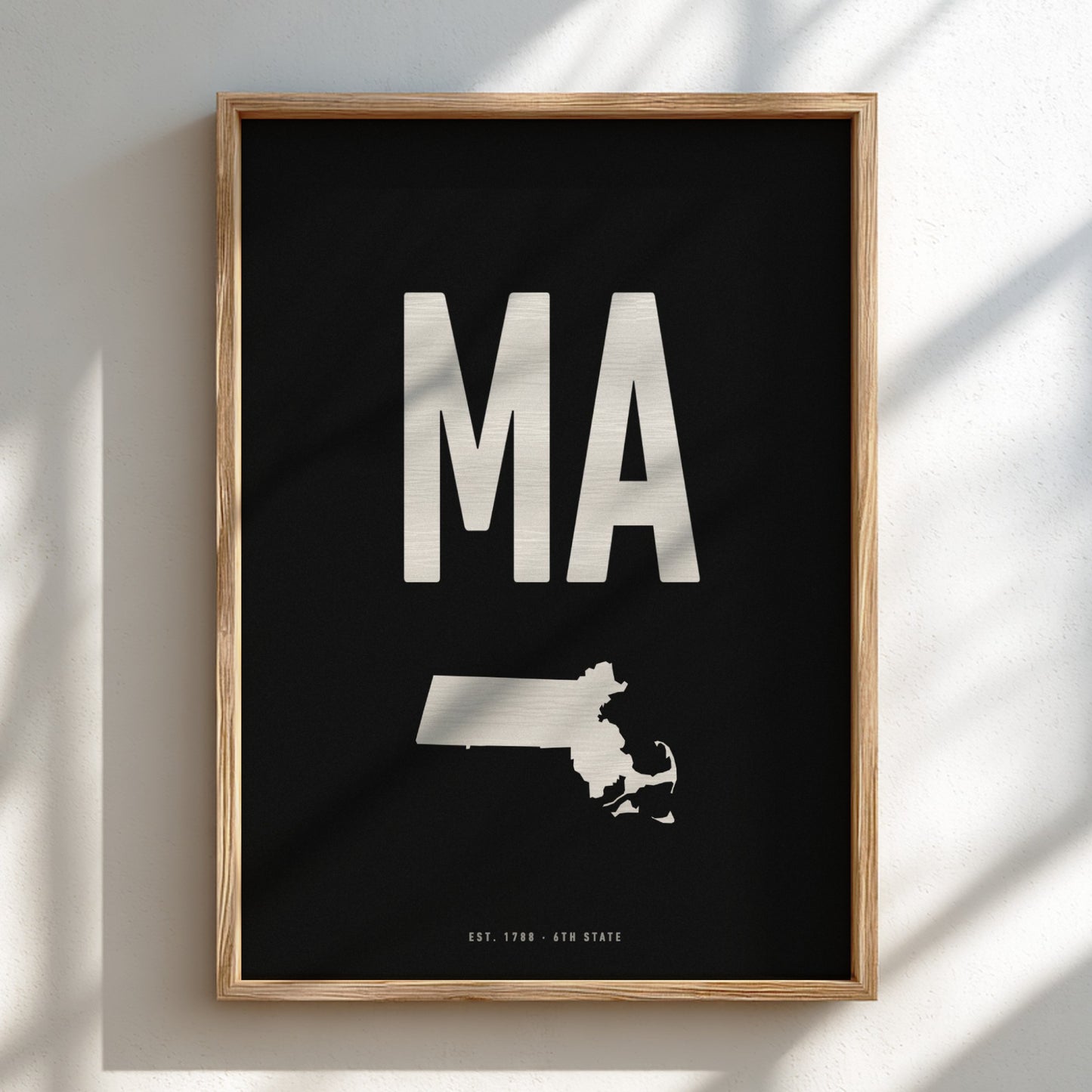 Framed poster with 'MA' and a map of Massachusetts on a black background