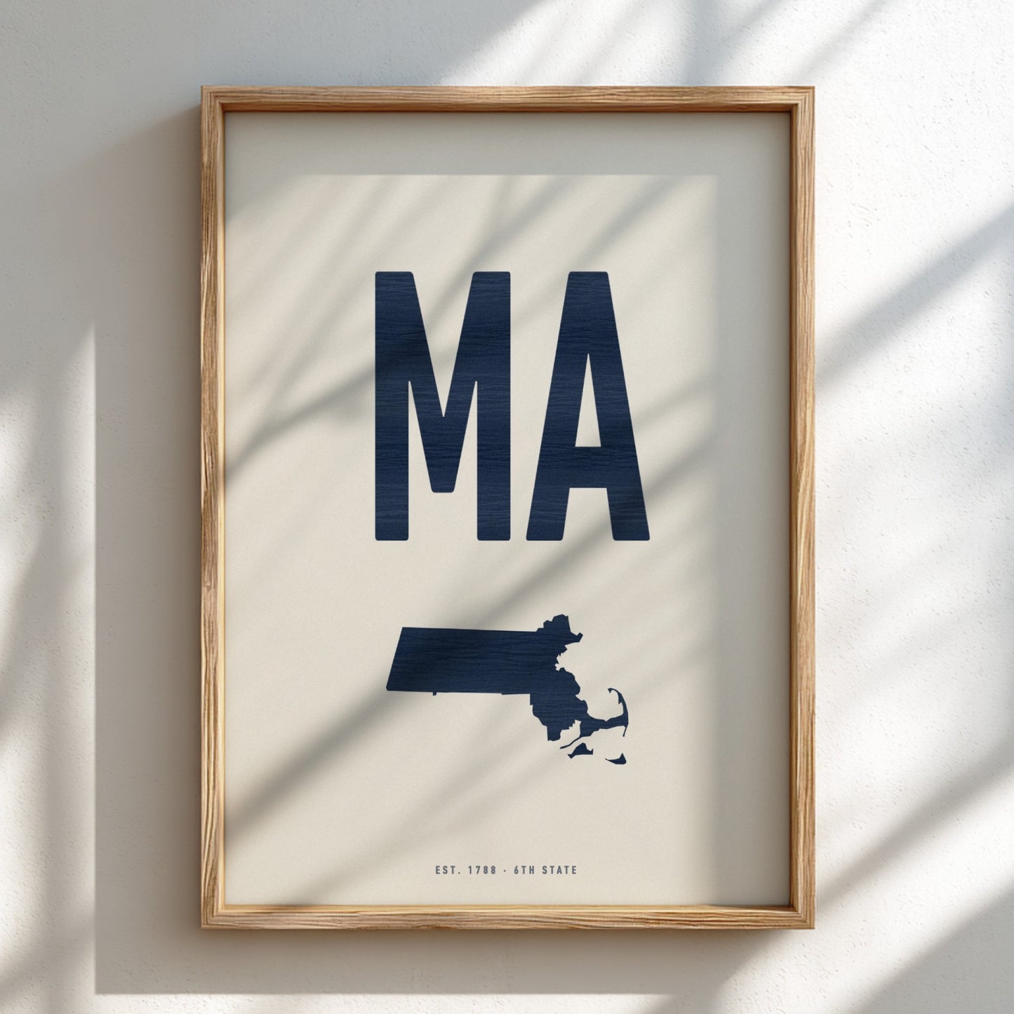 Framed artwork with 'MA' and a map of Massachusetts on a light background