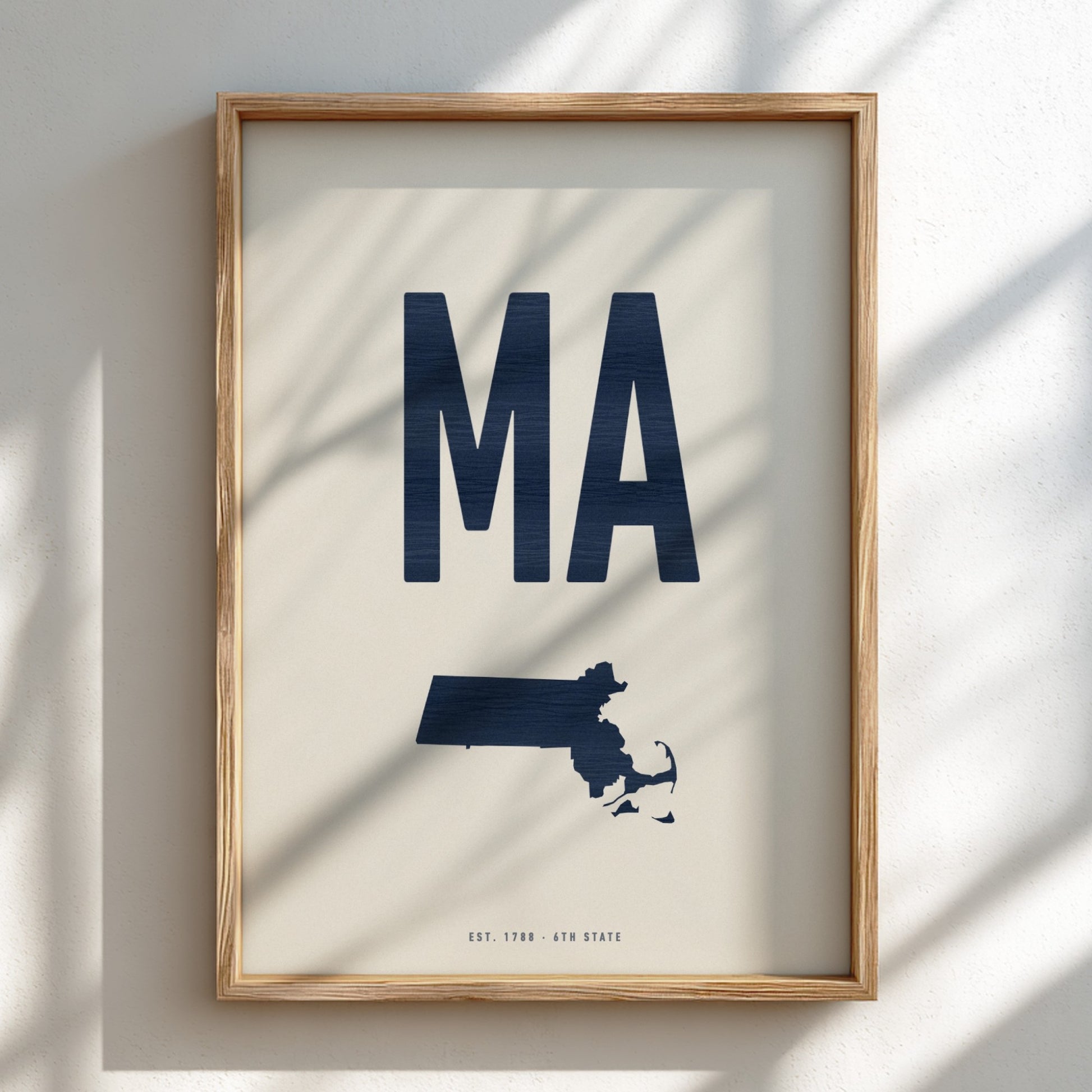 Framed artwork with 'MA' and a map of Massachusetts on a light background