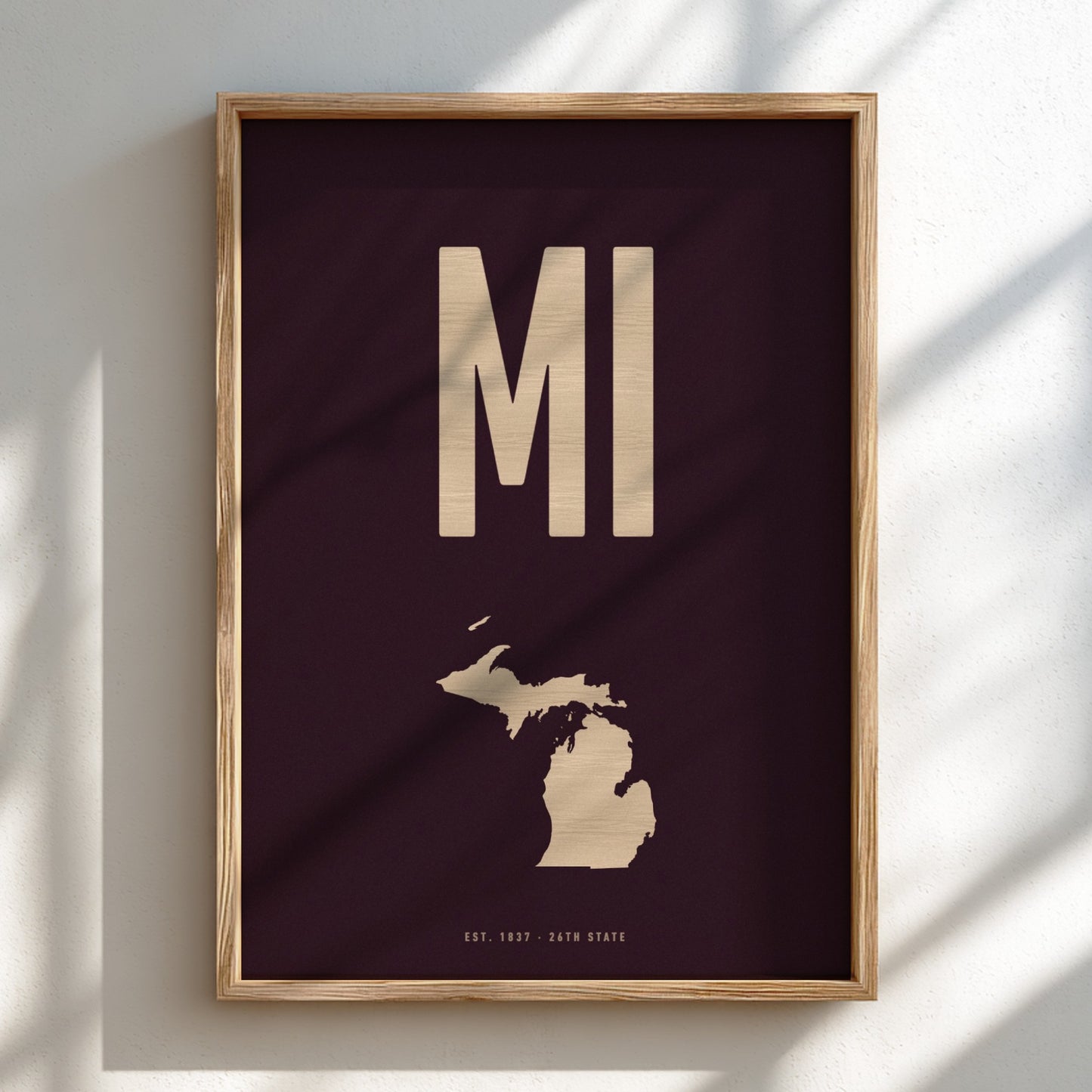 Framed artwork with 'MI' and a map of Michigan on a dark background