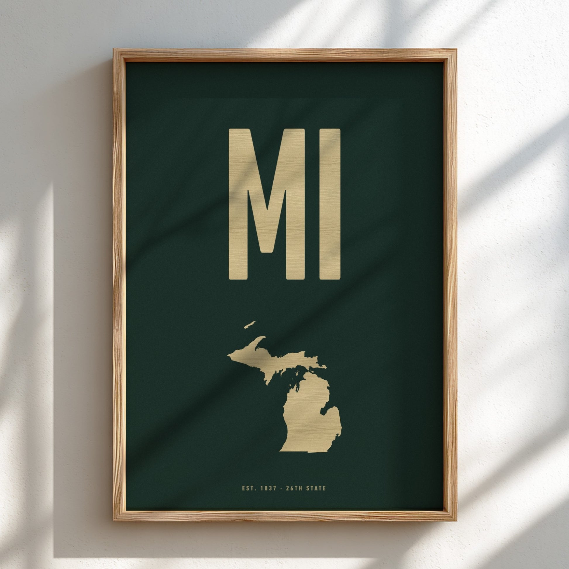 Framed artwork with 'MI' and a map of Michigan on a dark green background