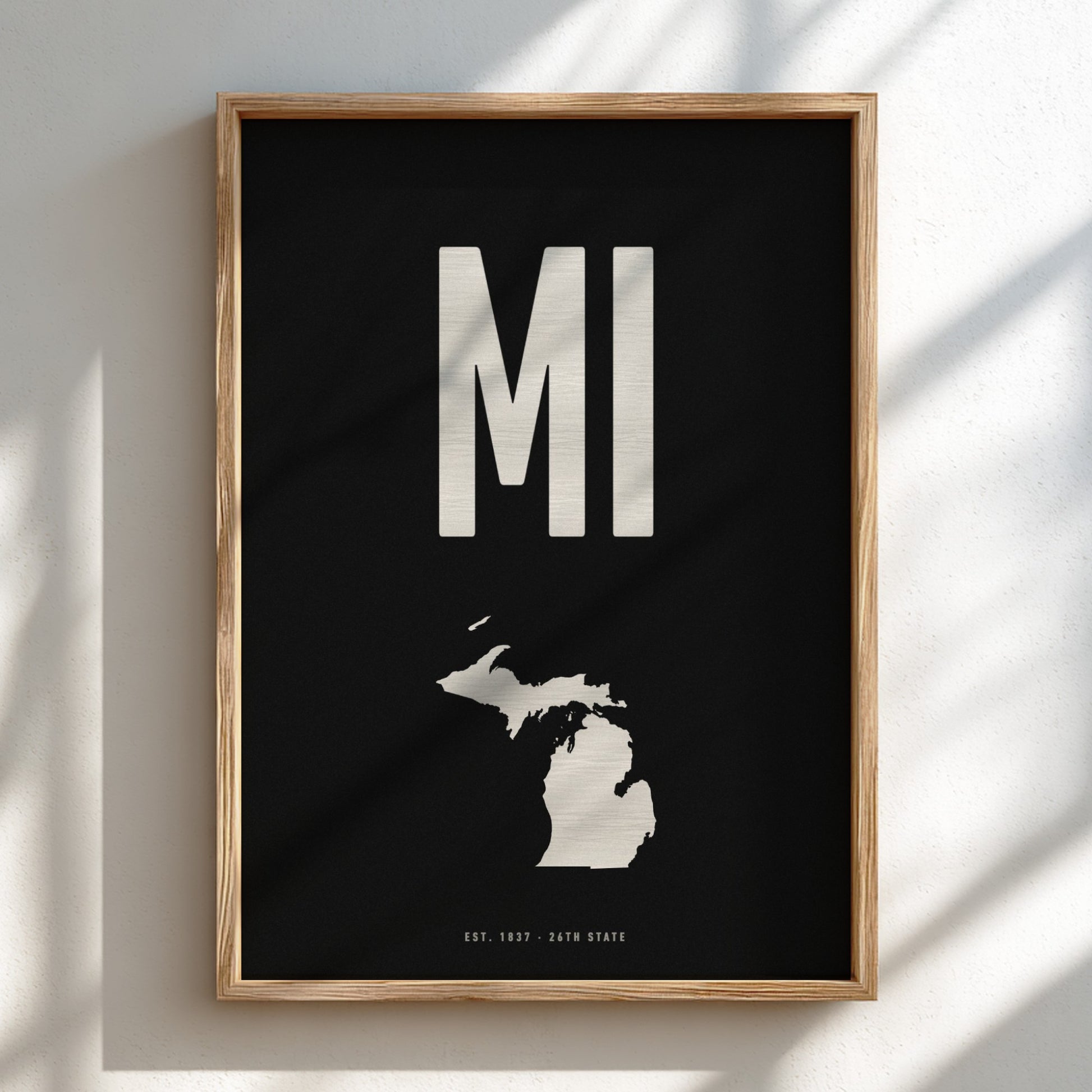 Framed poster with 'MI' and a map of Michigan on a black background