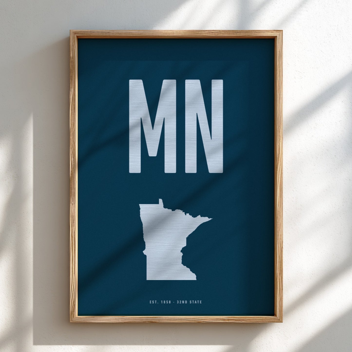 Framed poster with 'MN' and a map of Minnesota on a blue background