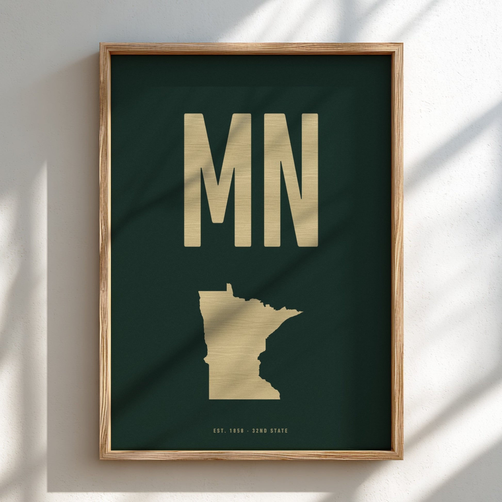 Framed artwork with 'MN' and a map of Minnesota on a dark green background