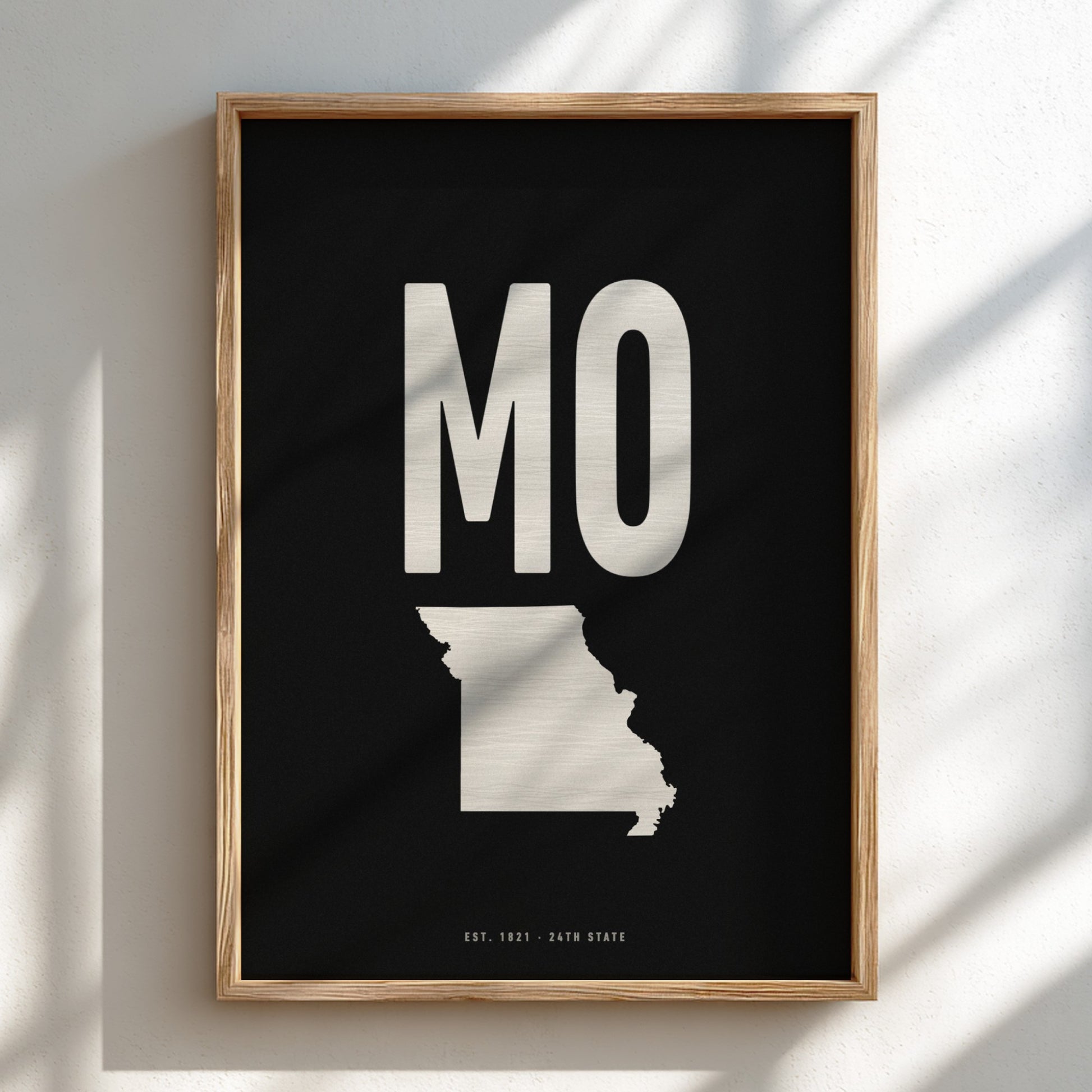 Framed artwork with 'MO' and a map of Missouri on a black background