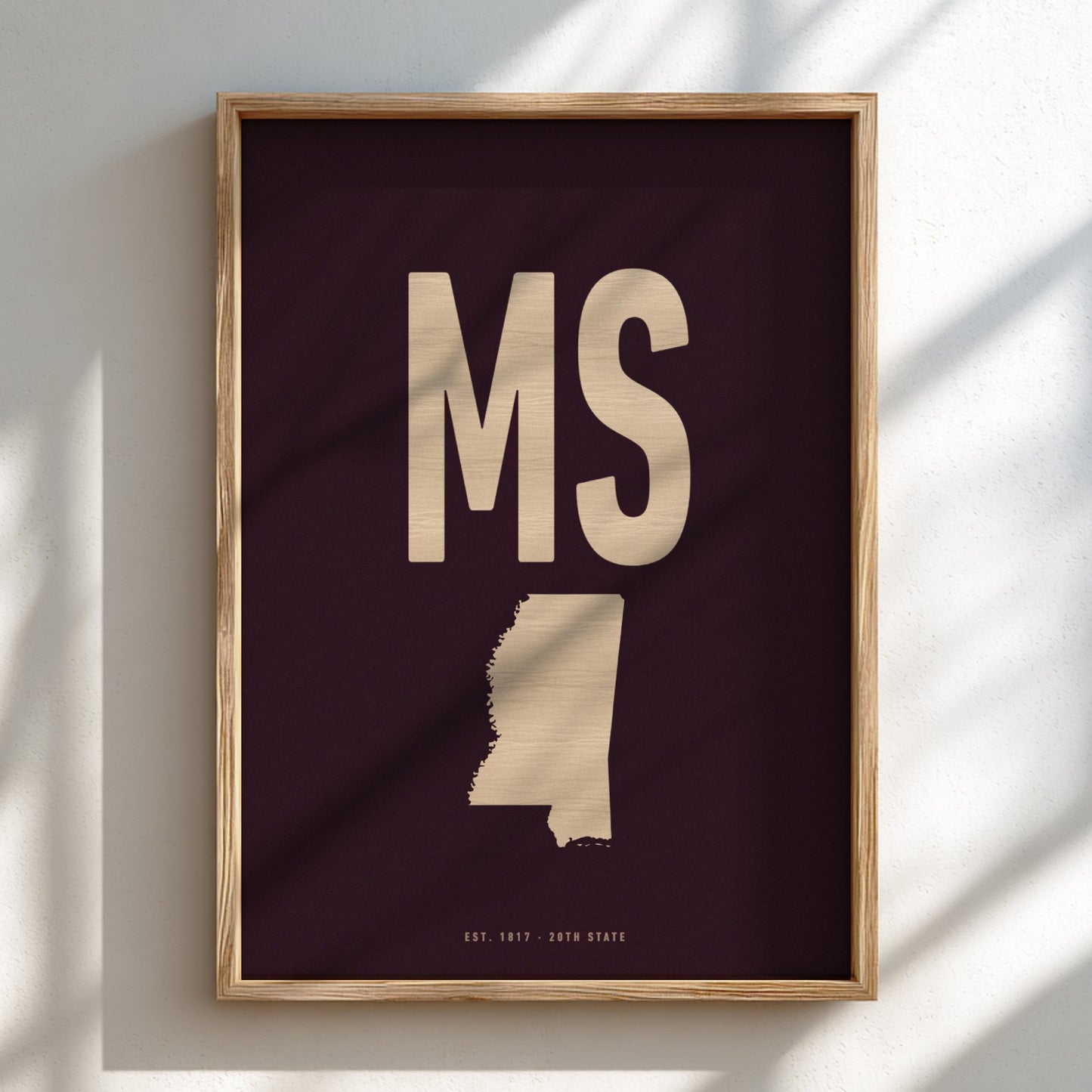 Framed artwork with 'MS' and a map of Mississippi on a dark background