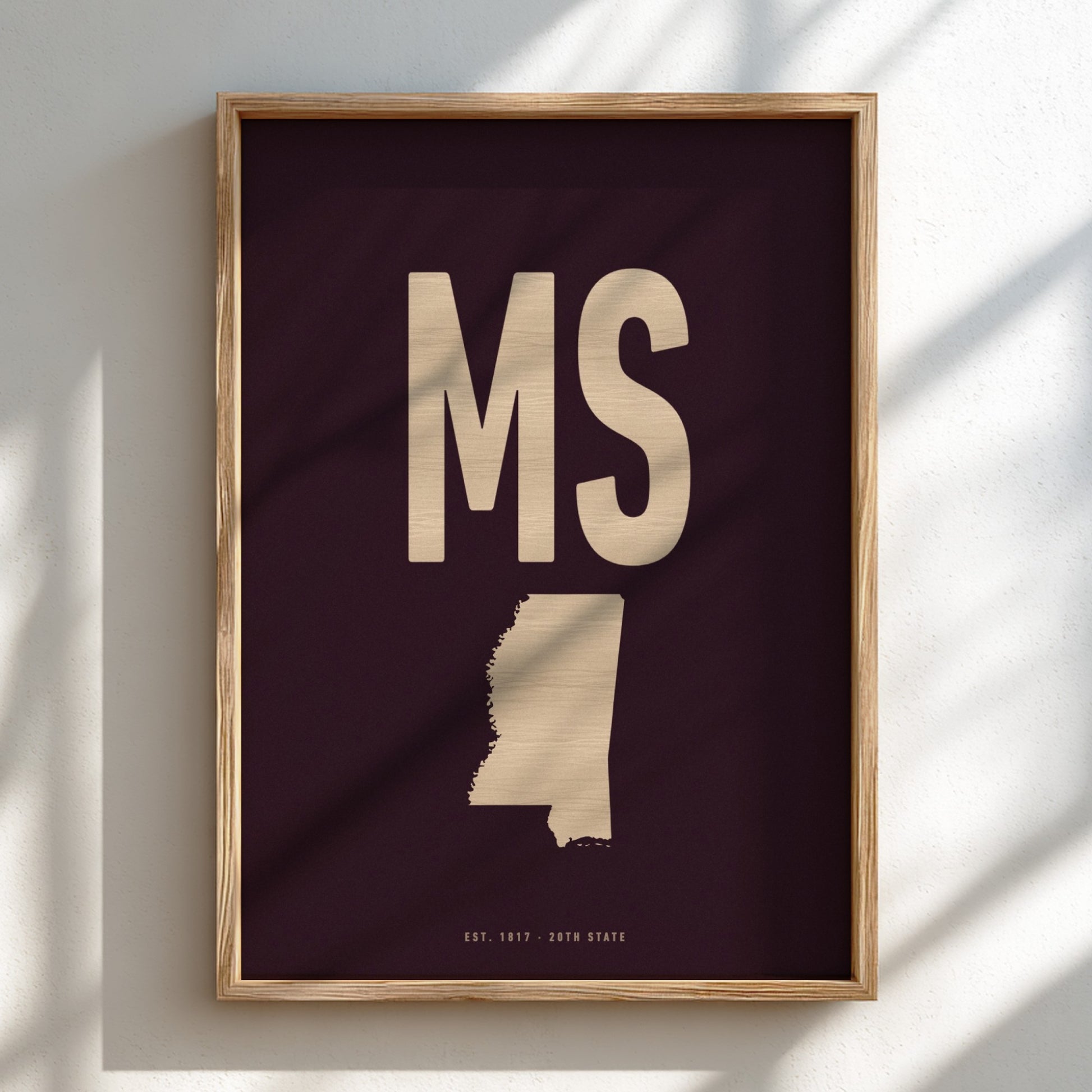 Framed artwork with 'MS' and a map of Mississippi on a dark background