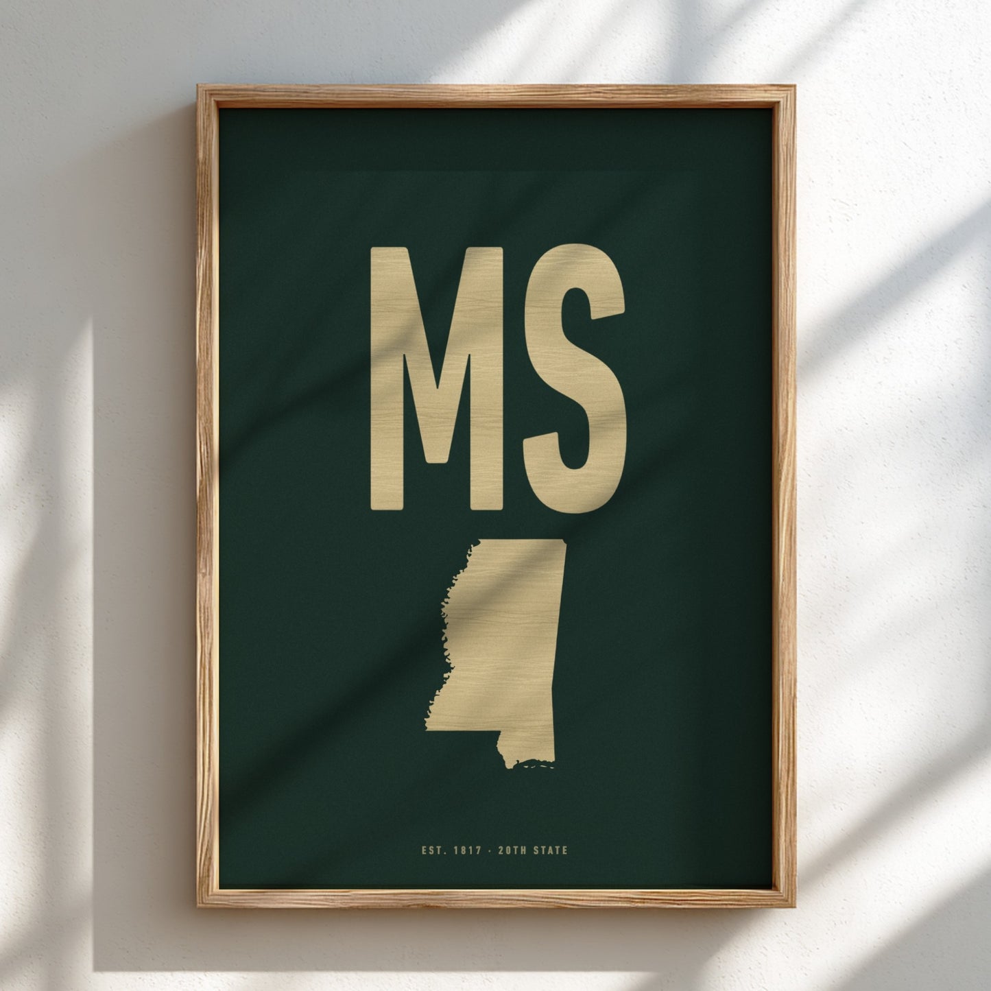 Framed artwork with 'MS' and map of Mississippi on a dark green background