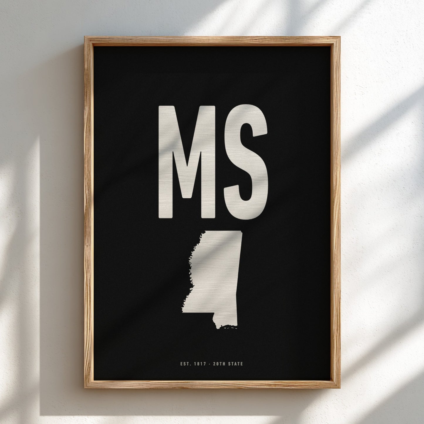 Framed artwork with 'MS' and a map of Mississippi on a black background